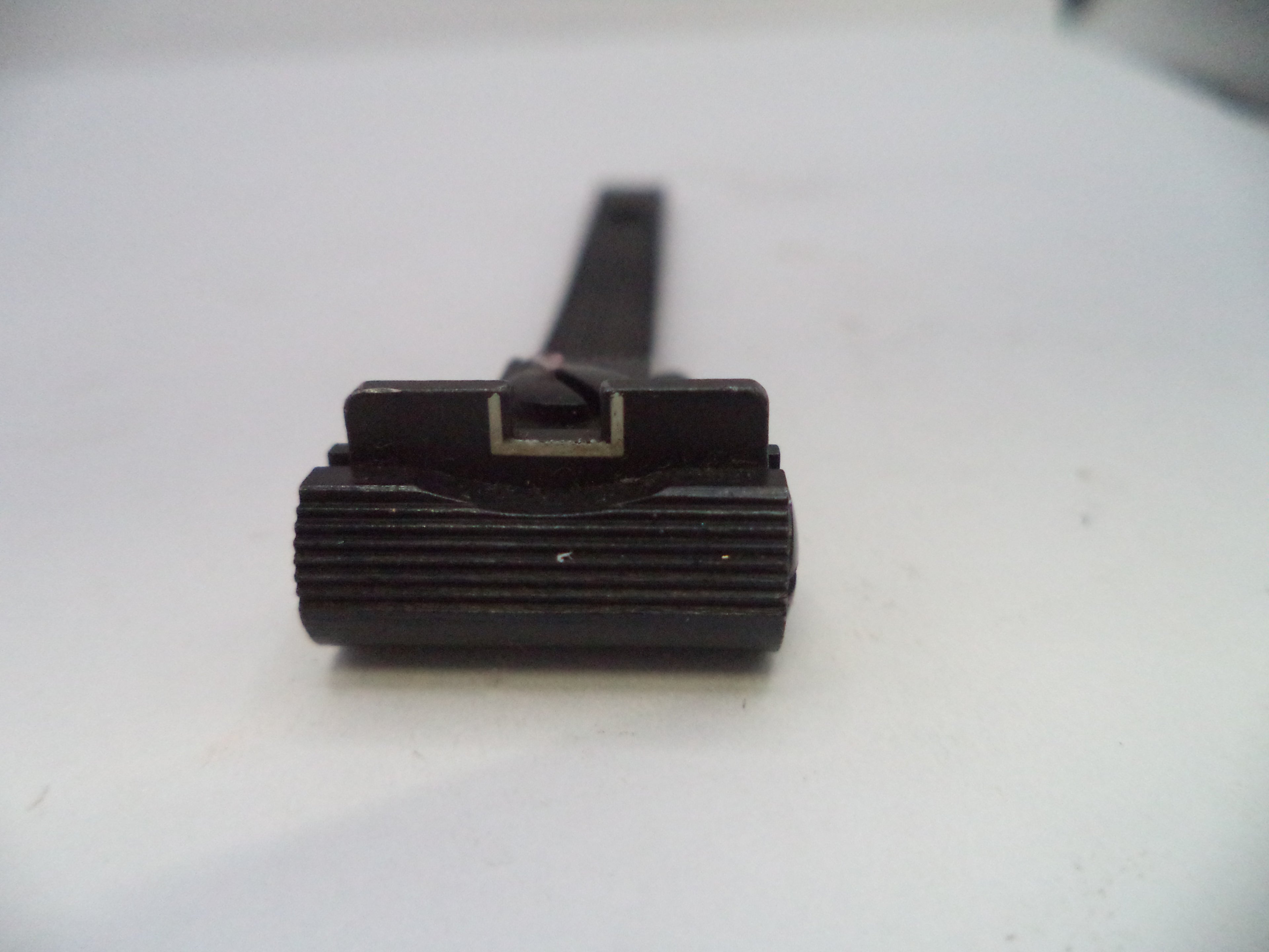 Black cylindrical object on a white background