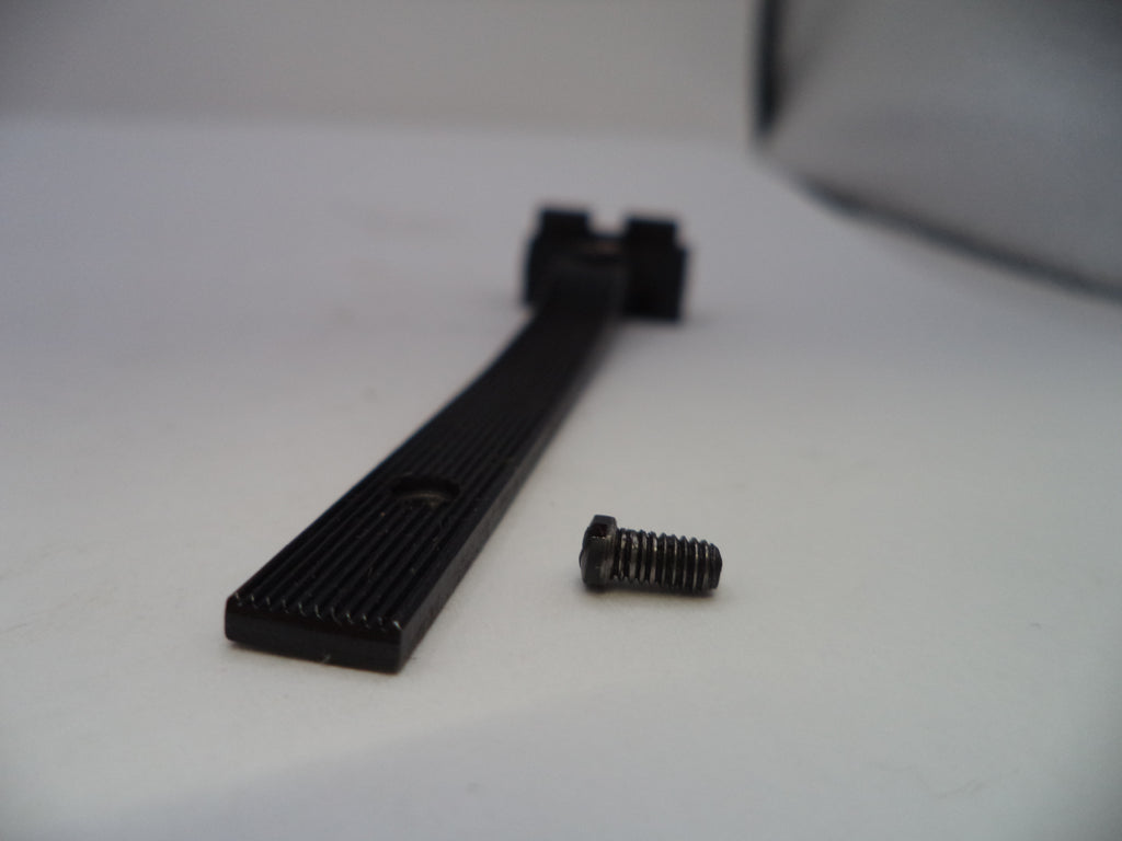 Black metal screw on a white surface