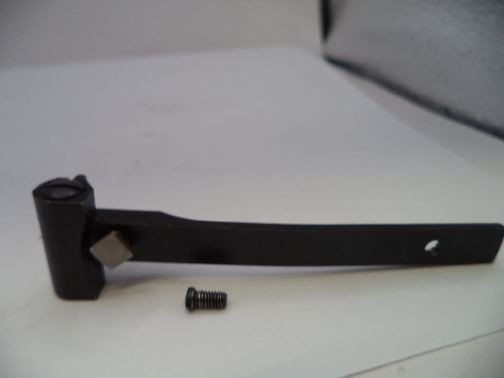 Black metal lever with a screw on a white surface