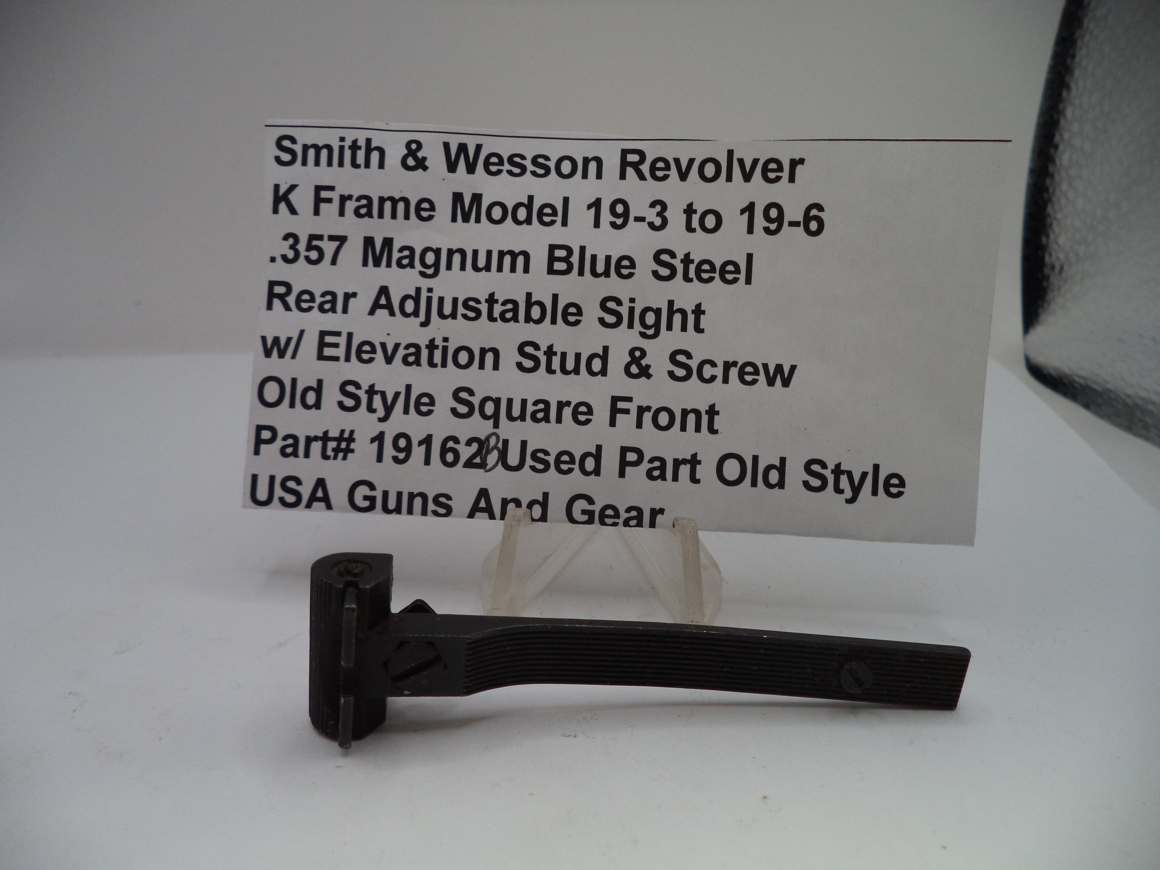 Smith & Wesson revolver part with descriptive label on a white background