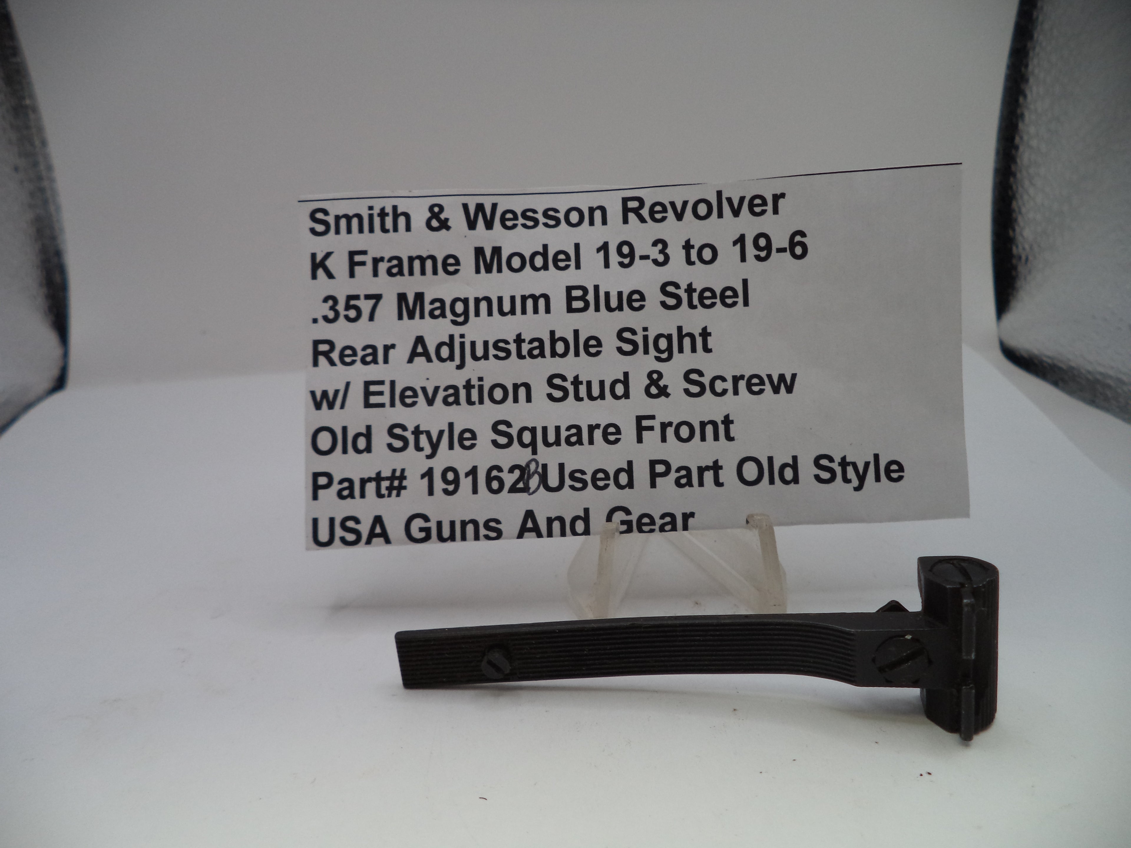 Smith & Wesson revolver part with descriptive label on a white background