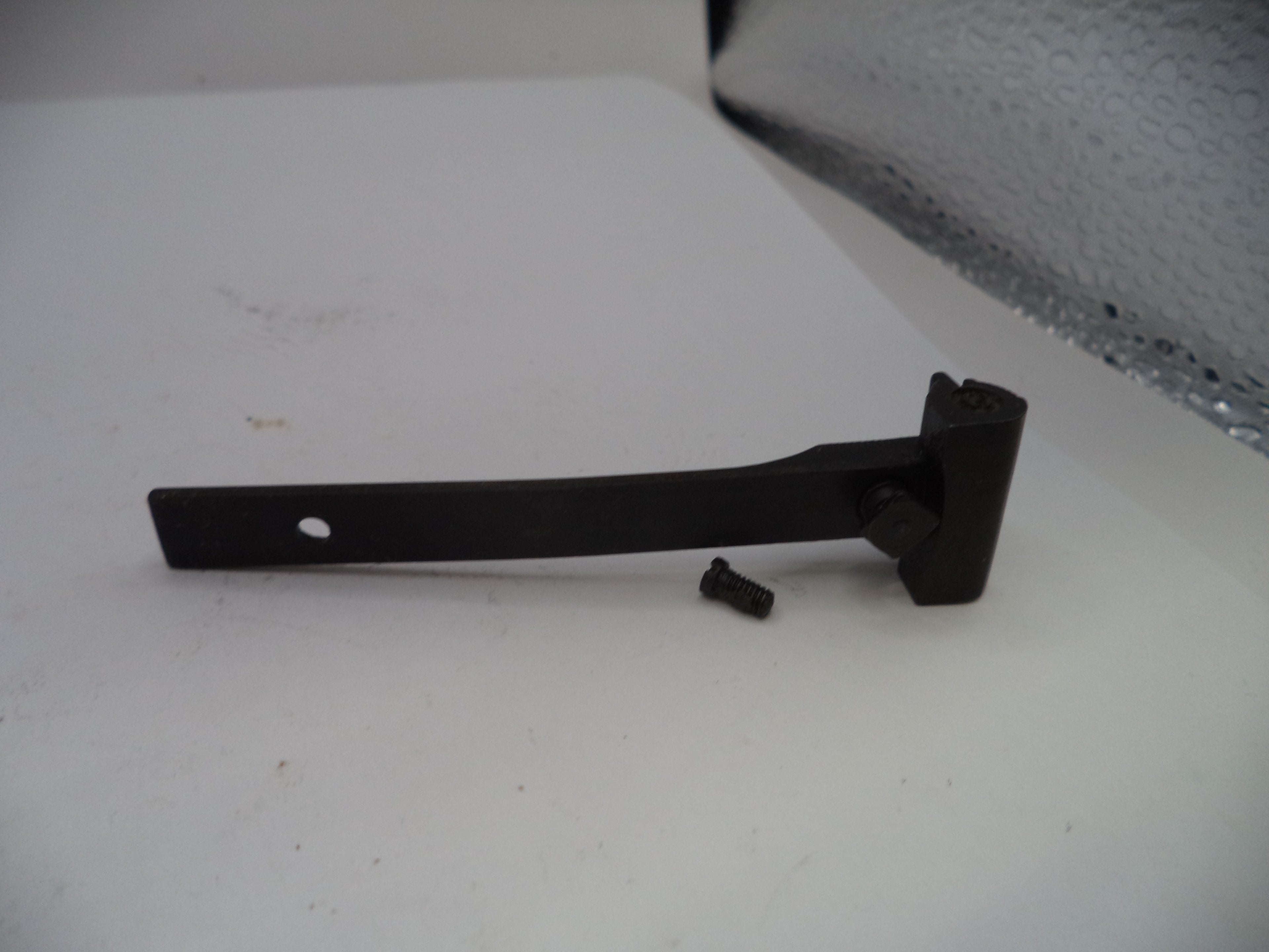 Black metal bracket on a white surface