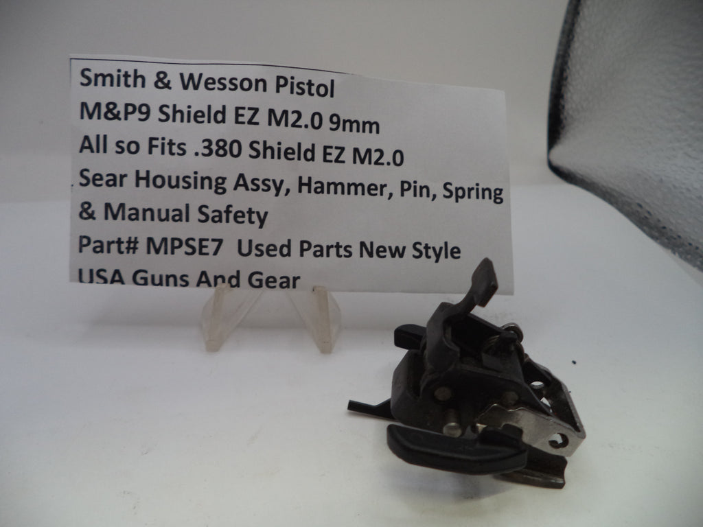 Smith & Wesson pistol part on a white background with a label.