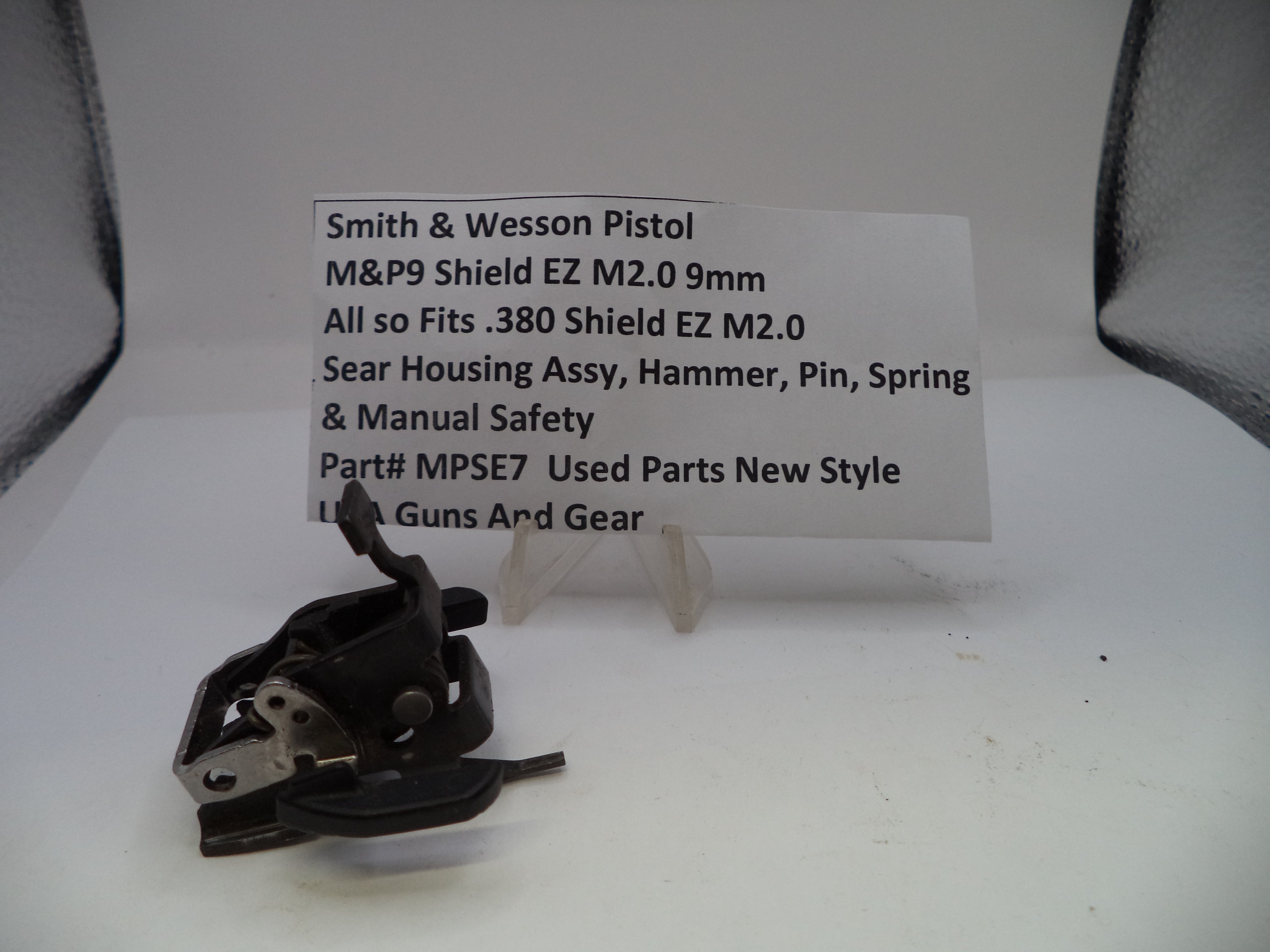 Smith & Wesson pistol part on a white background with a label