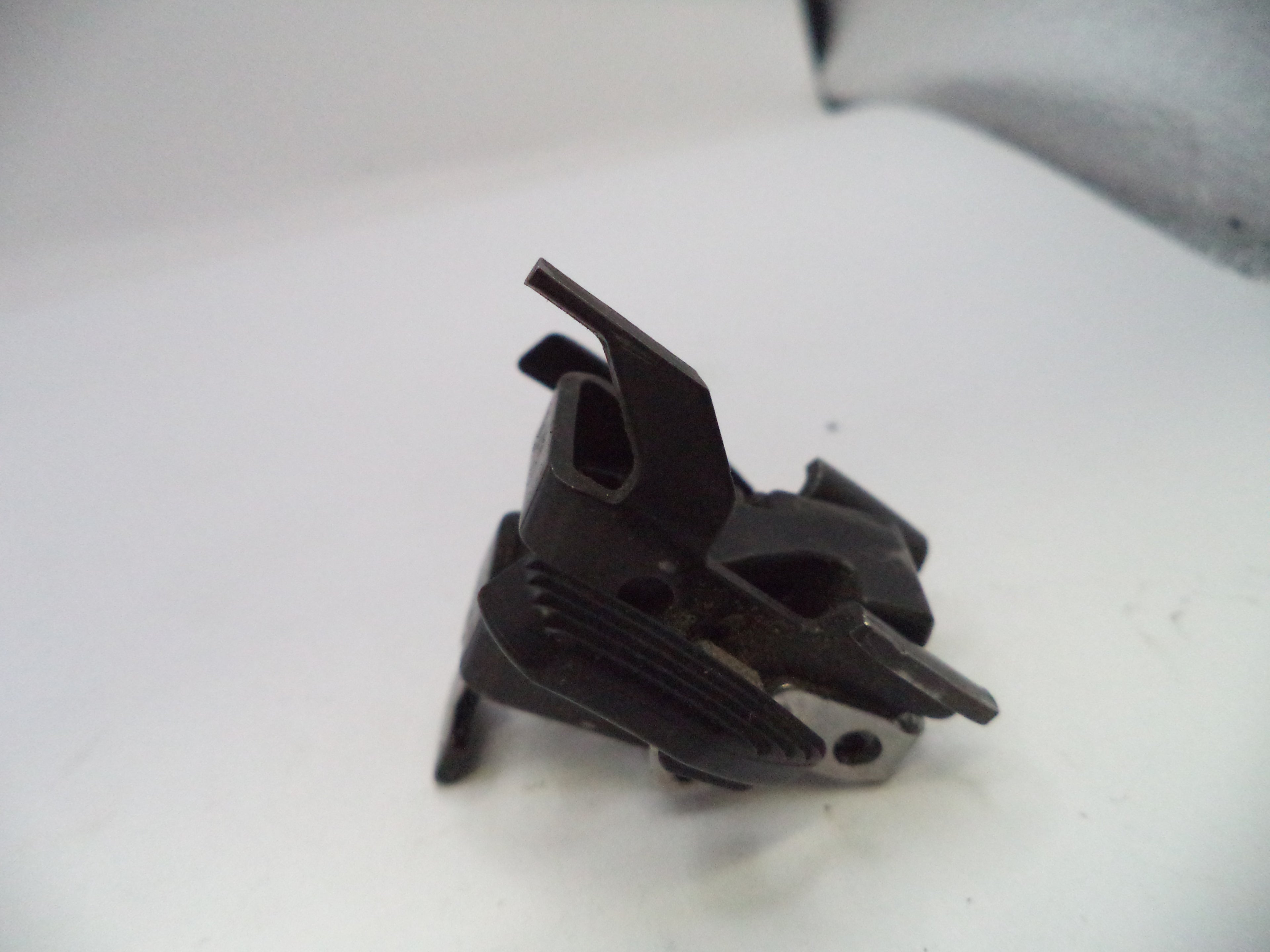 Black mechanical component on a white background