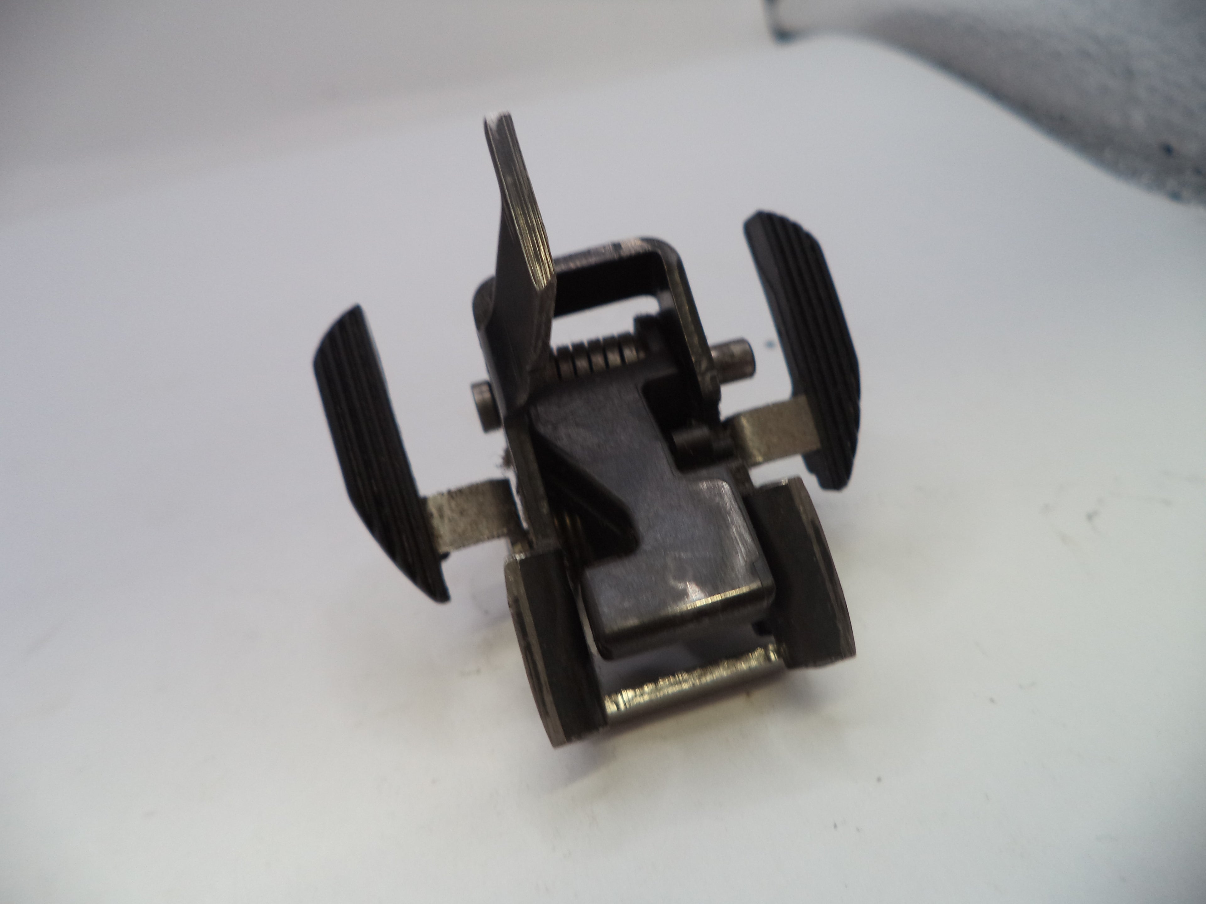 Metal clip or fastener on a white surface
