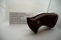 A brown vintage wood target grip for a Smith & Wesson revolver, displayed on a white surface with a label providing model and pricing information.