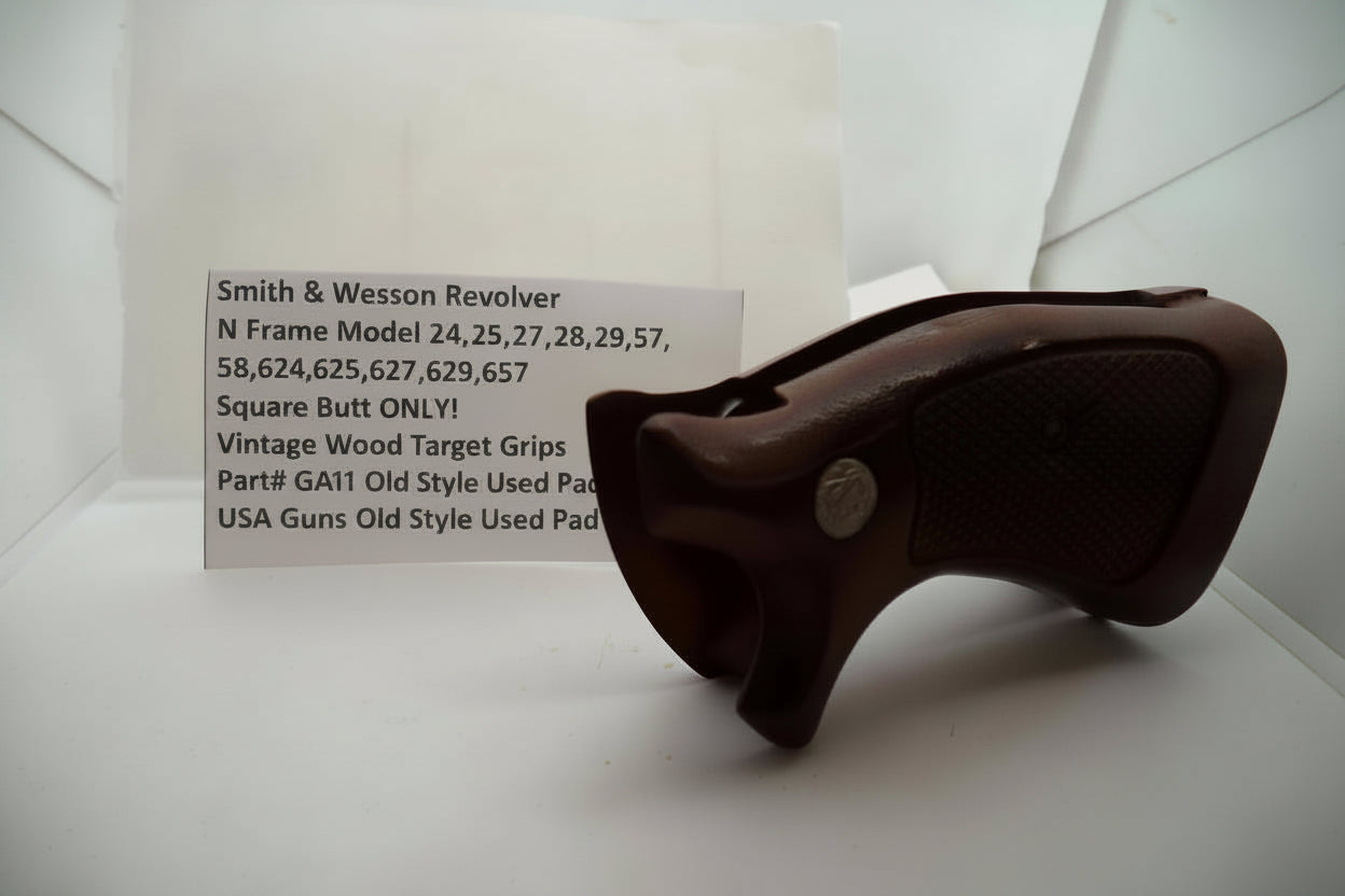 A brown vintage wood target grip for a Smith & Wesson revolver, displayed on a white surface with a label providing model and pricing information.