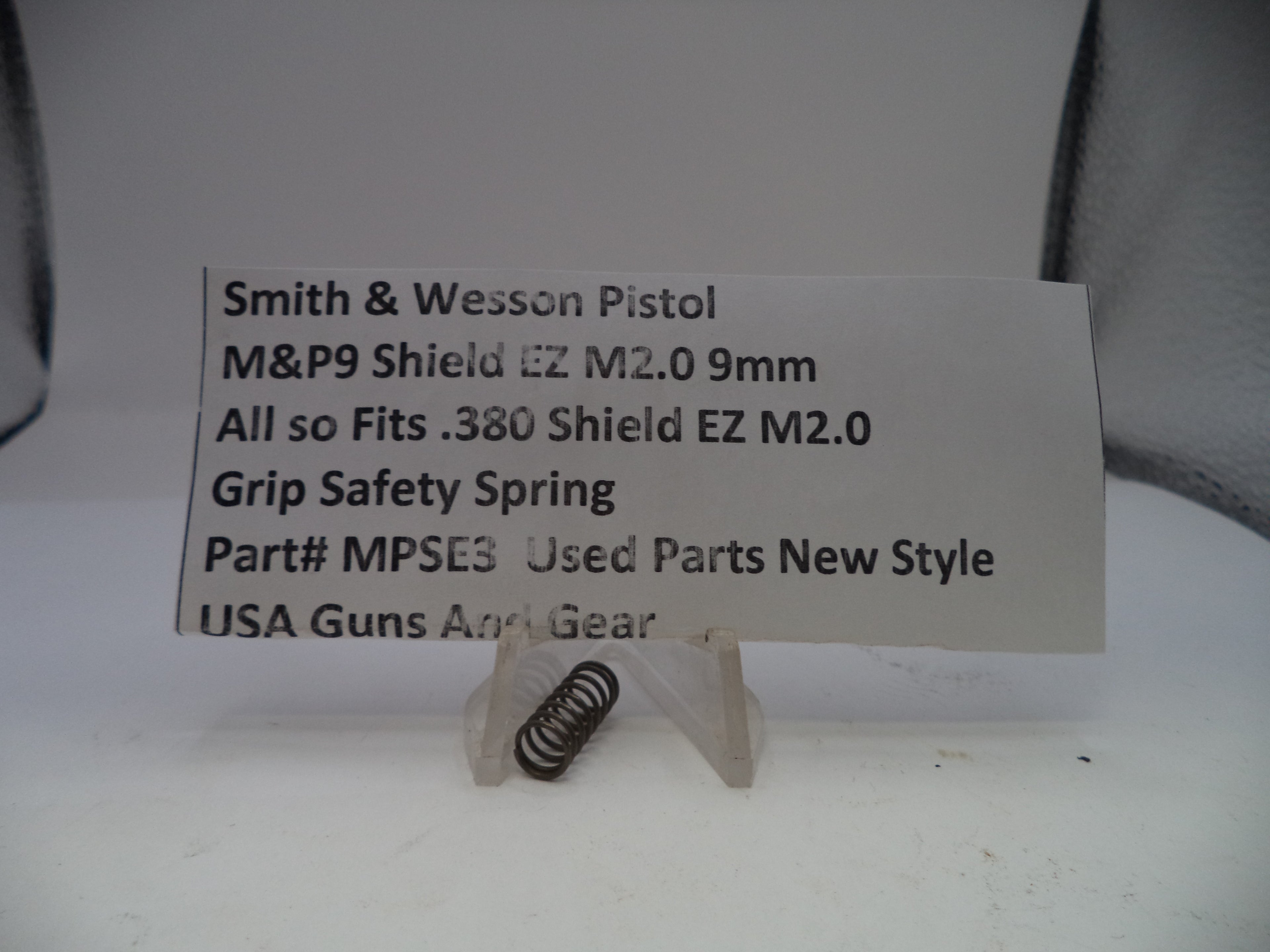 Grip safety spring for Smith & Wesson pistol on a white card with product details.