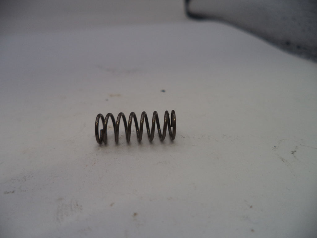 Coiled spring on a white surface