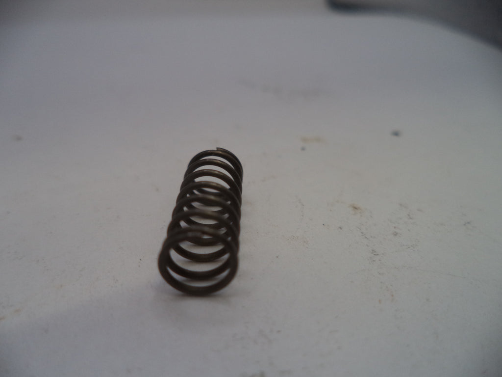 Coiled spring on a white surface