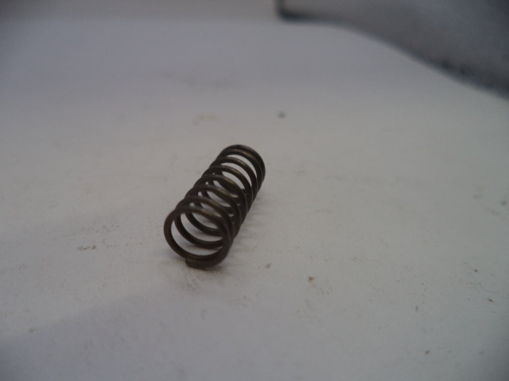 Coiled spring on a white surface