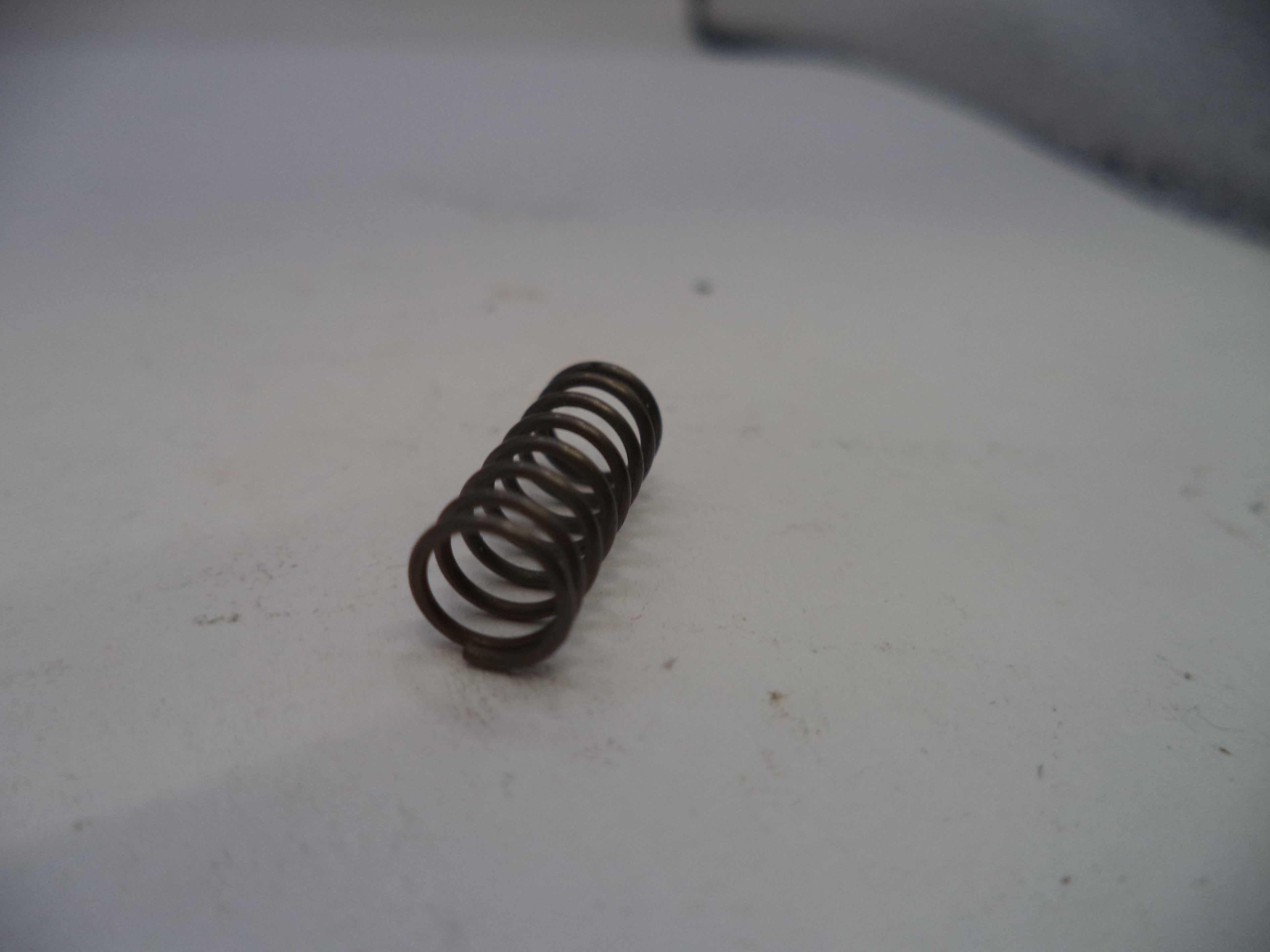 Coiled spring on a white surface