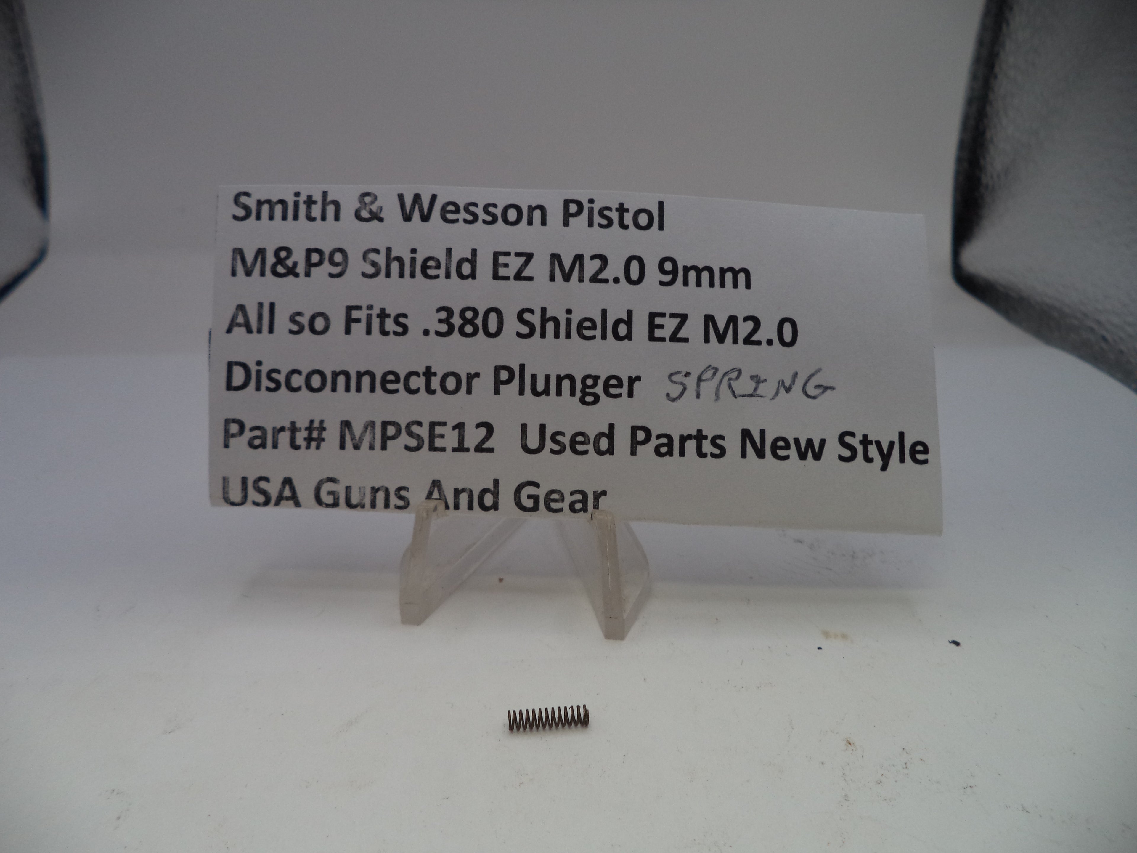Disconnector plunger spring for Smith & Wesson pistol on a white background with descriptive text card.
