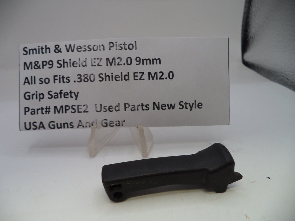 Black grip safety for Smith & Wesson pistol on a white background with a label.