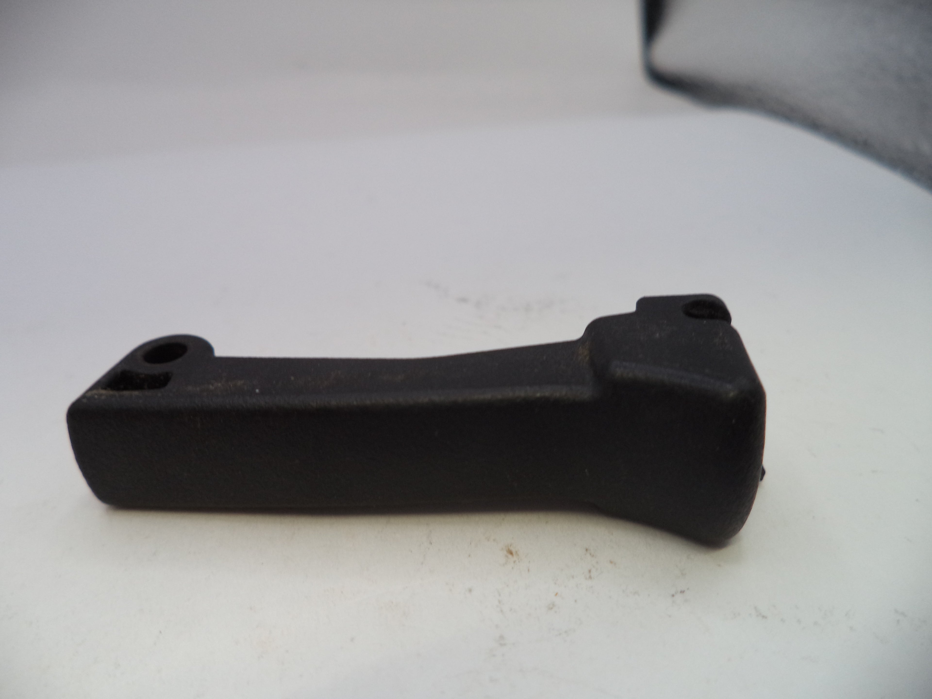 Black plastic component on a white background