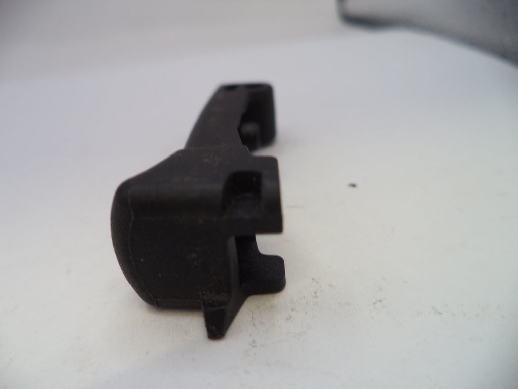 Black plastic component on a white surface