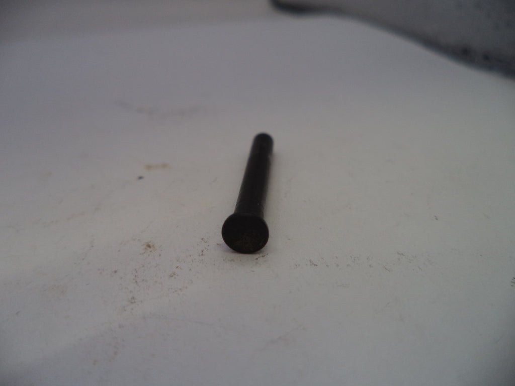 Black cylindrical object on a white surface