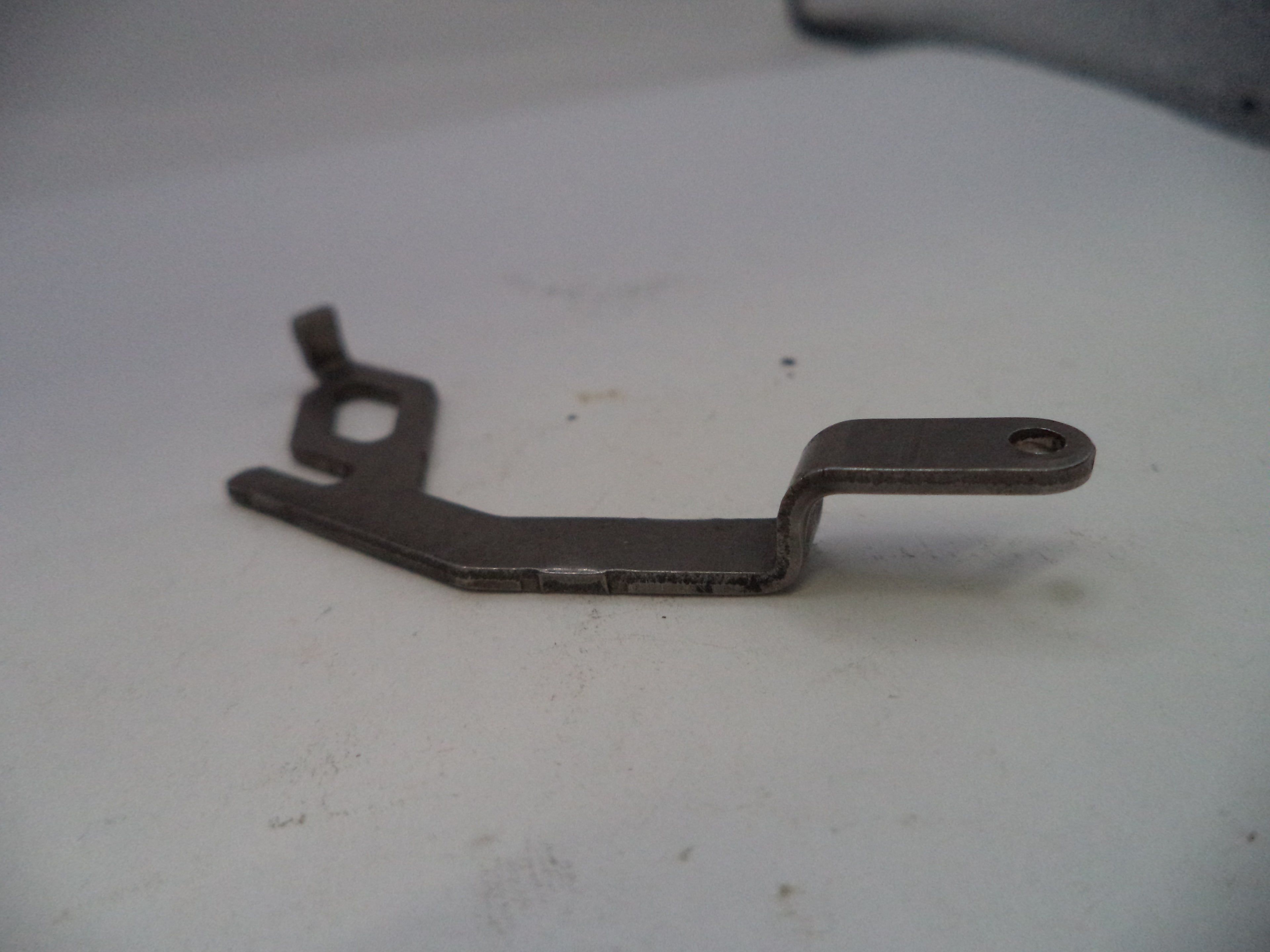 Metallic lever or arm on a white surface