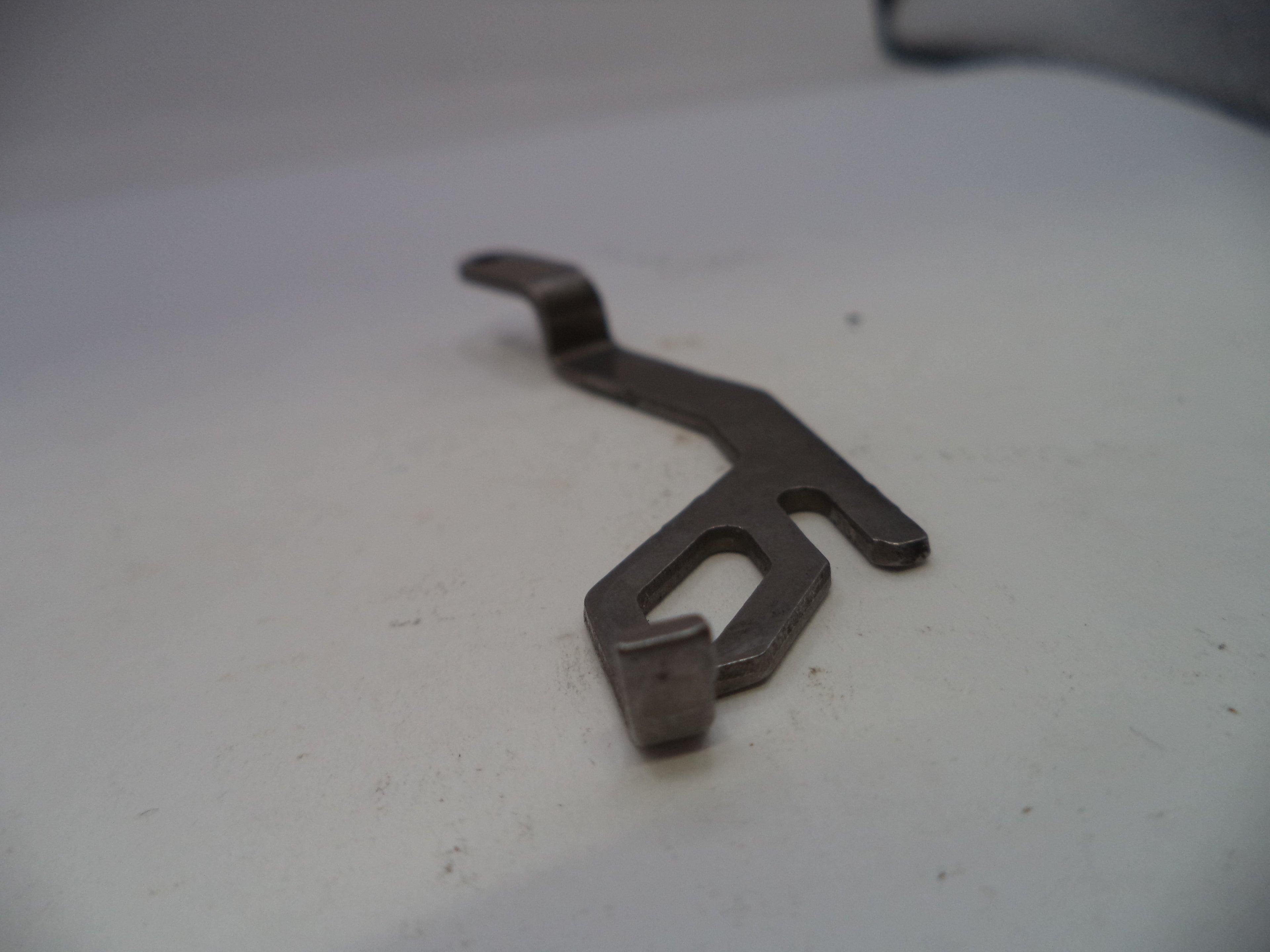 Metal wrench on a white surface