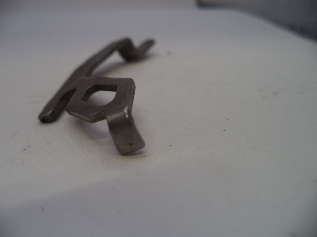 Metallic key-shaped object on a white surface