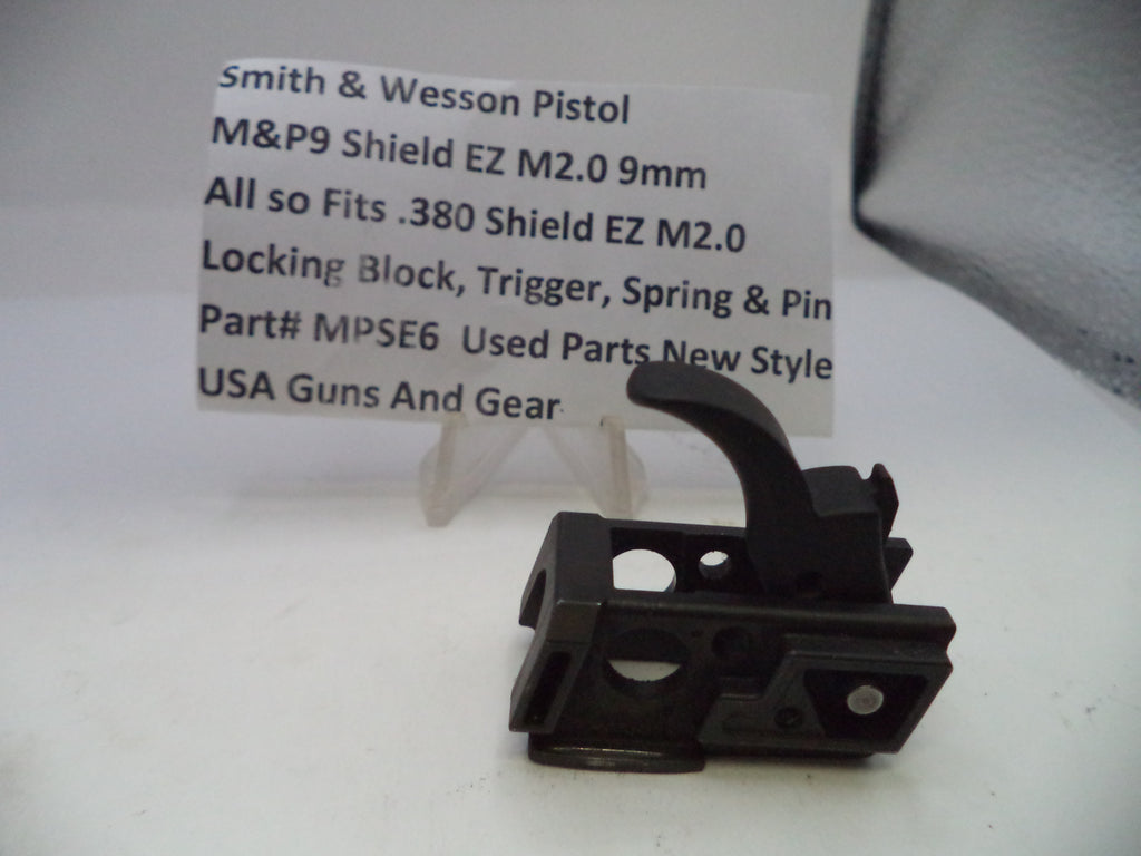 Black gun part with a label on a white background