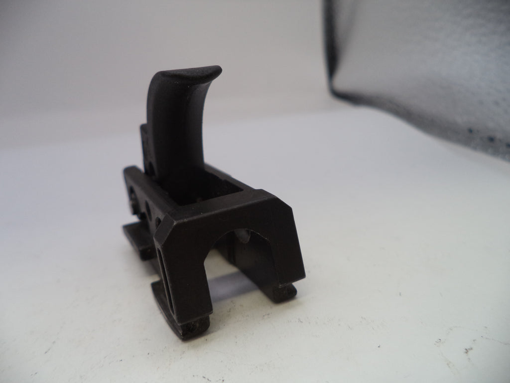 Black plastic component on a white surface