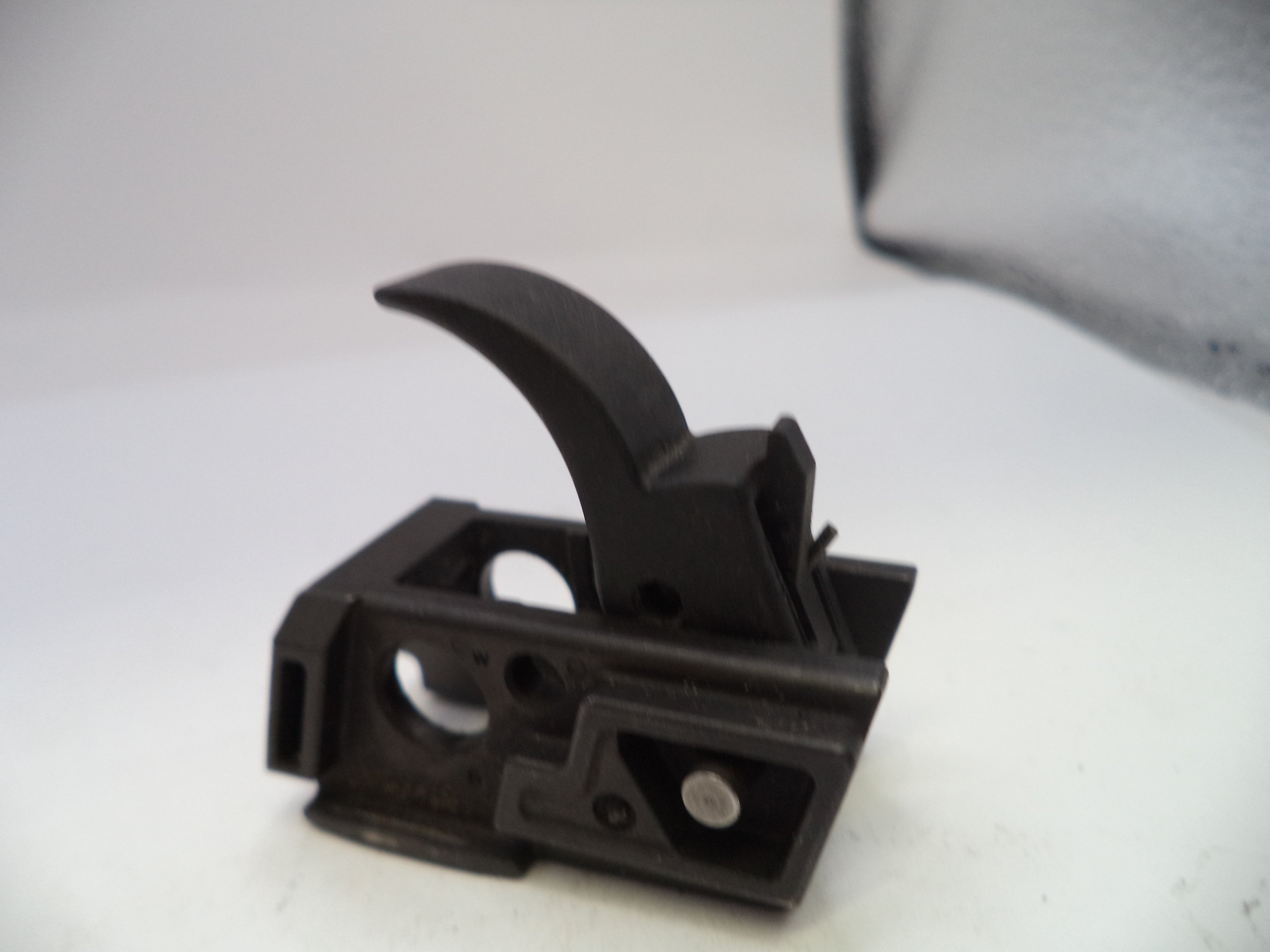 Black plastic component on a white background