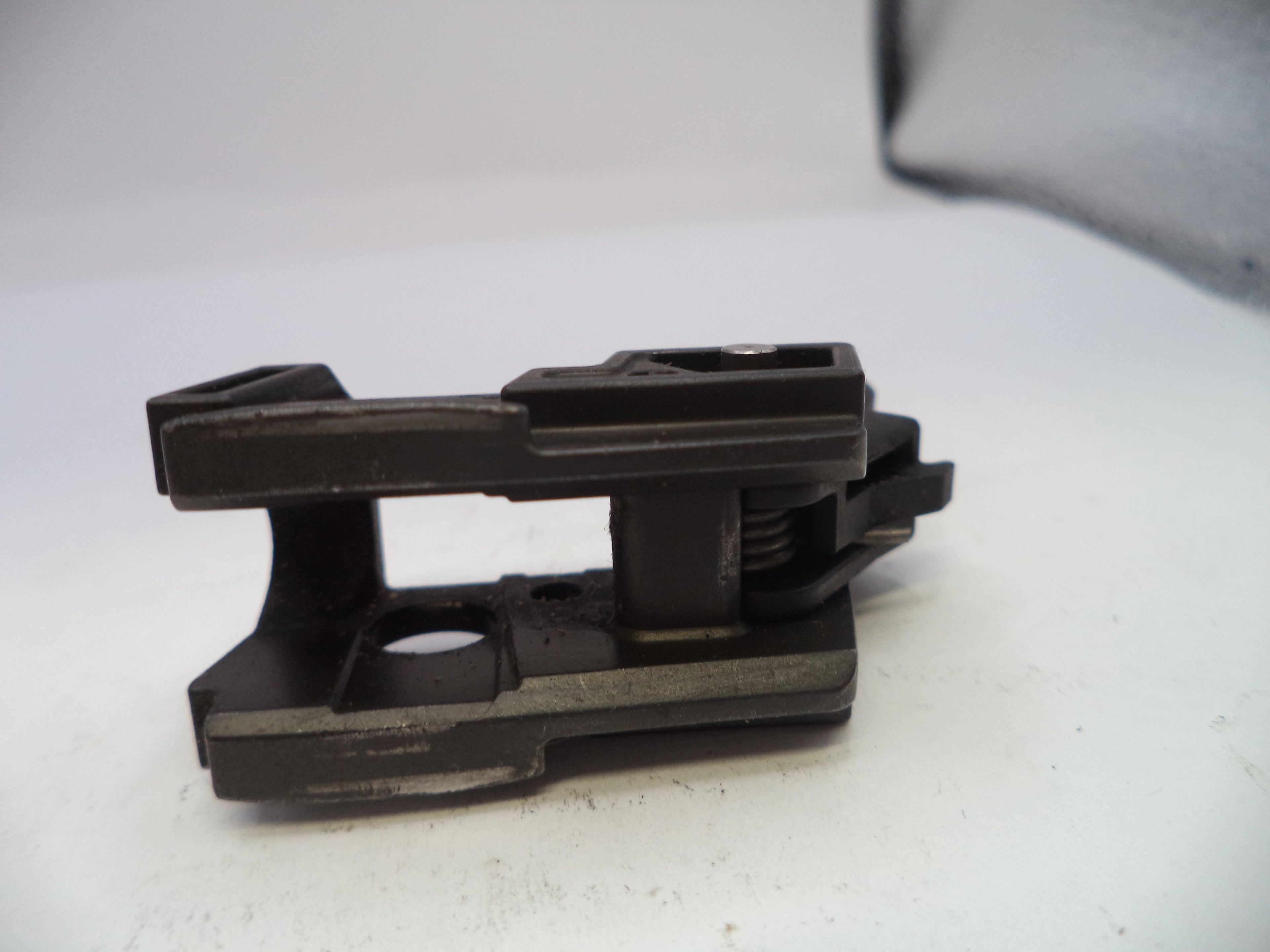 Black metal bracket on a white surface