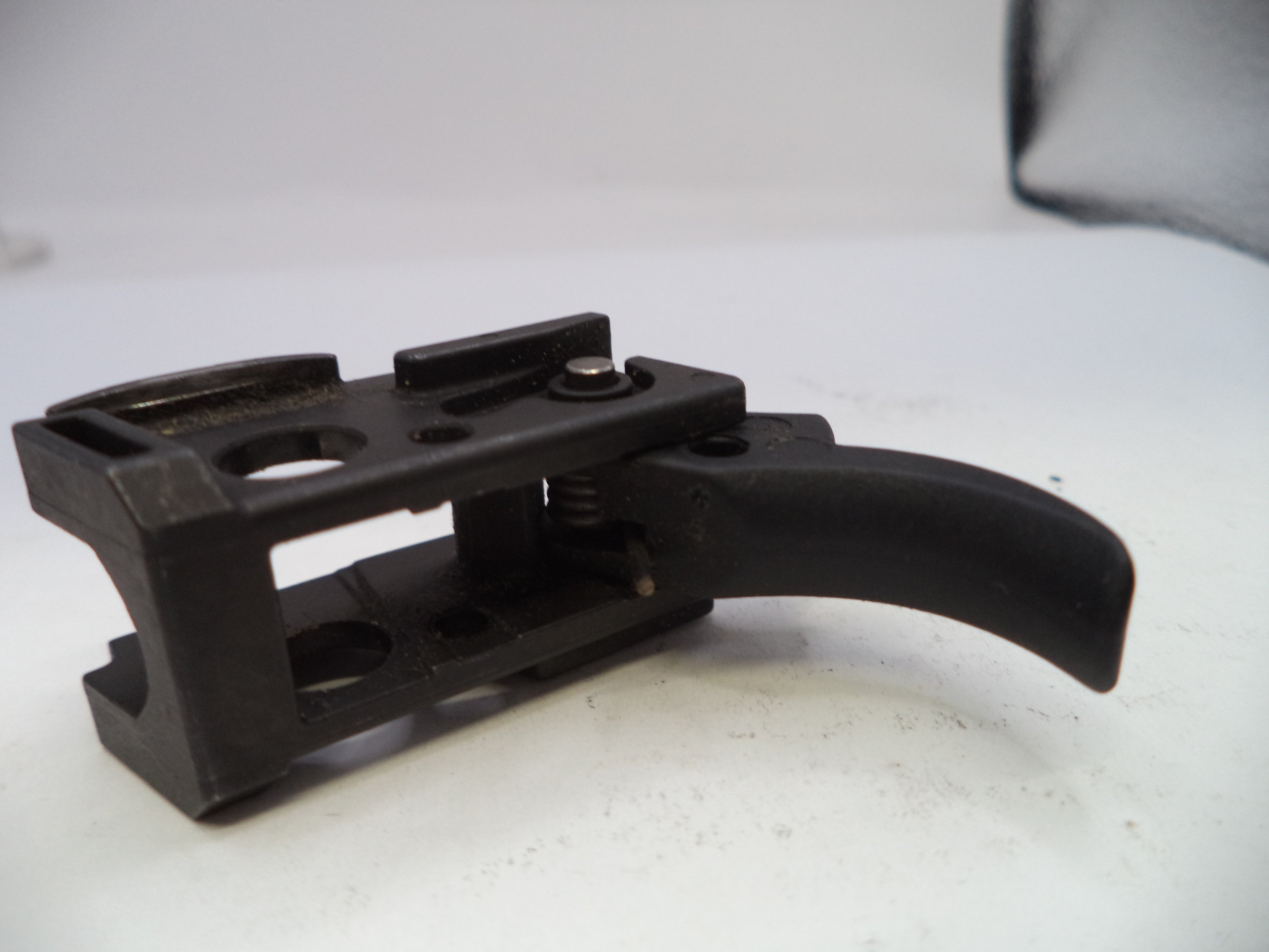 Black metal bracket on a white surface
