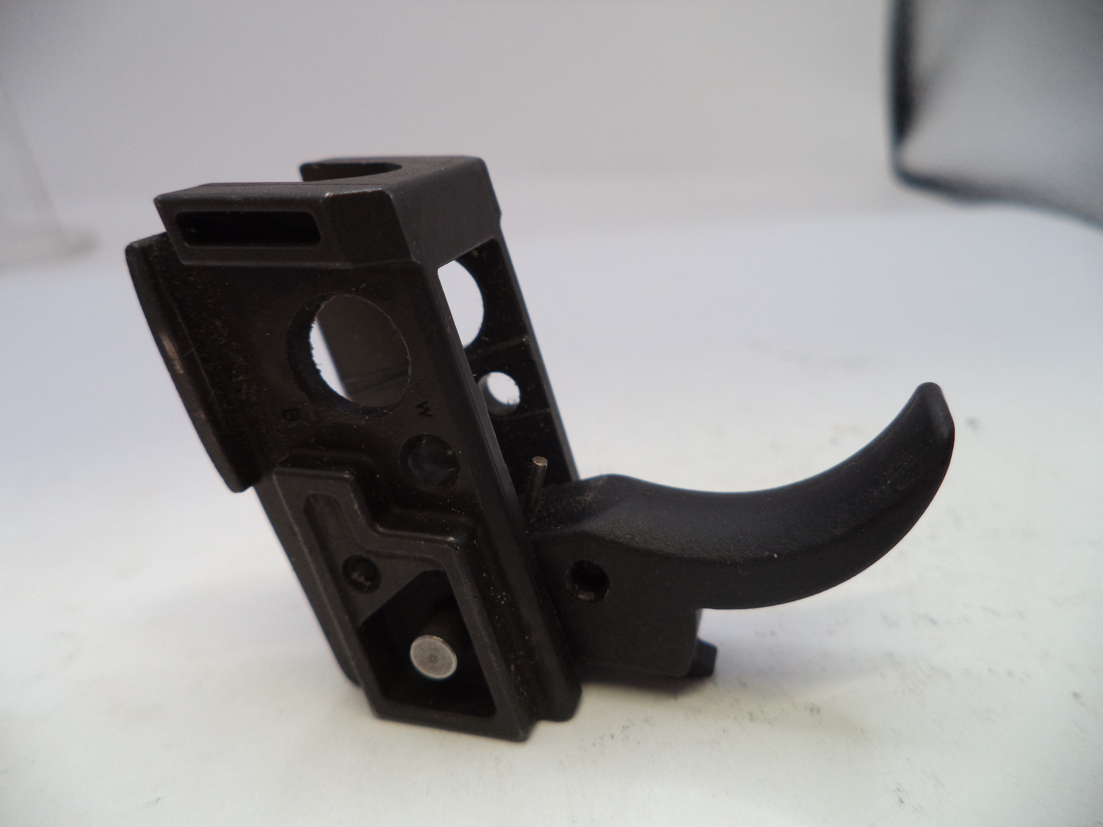 Black plastic component on a white background