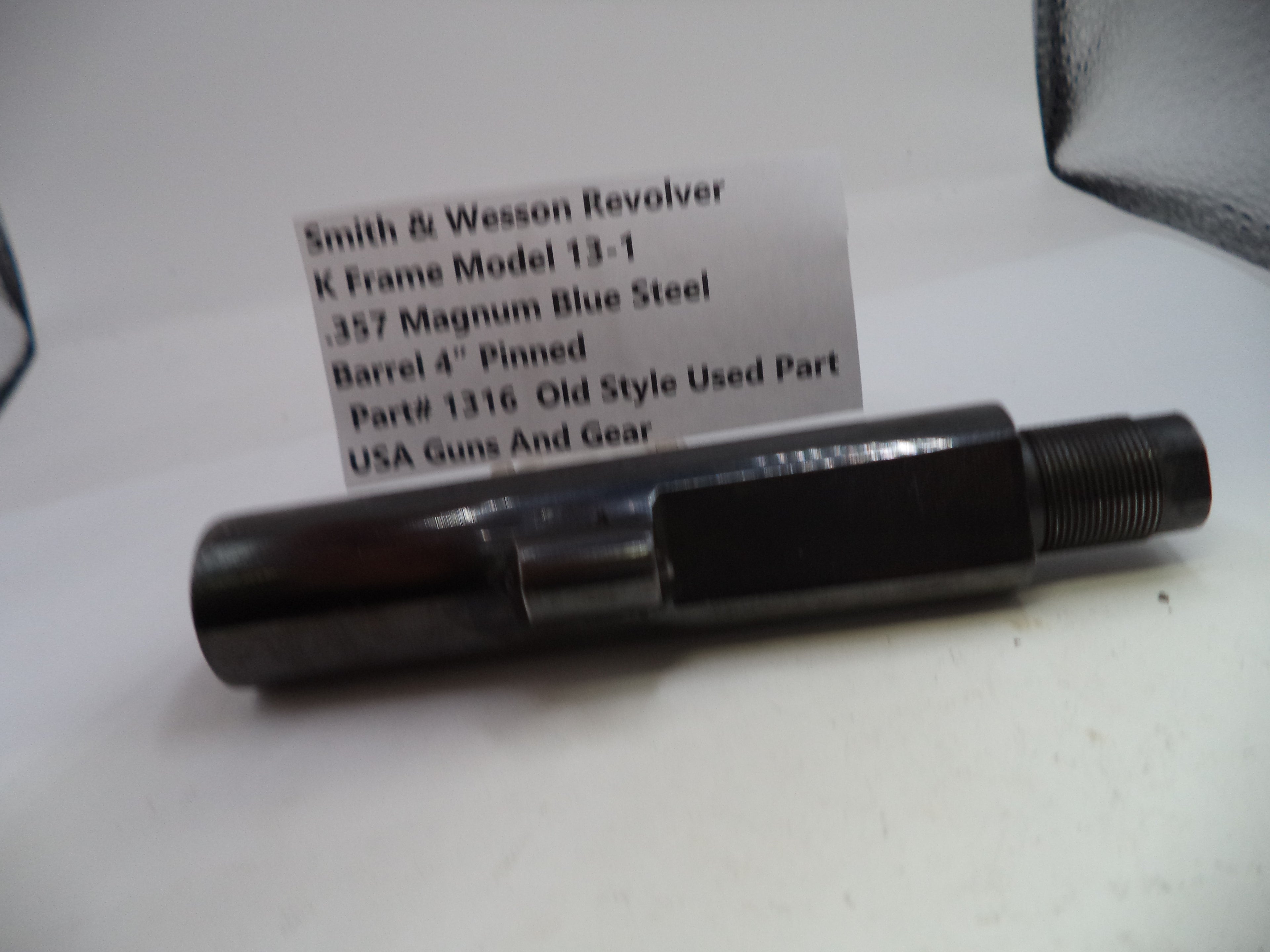 Smith & Wesson revolver barrel on a white background with a label.