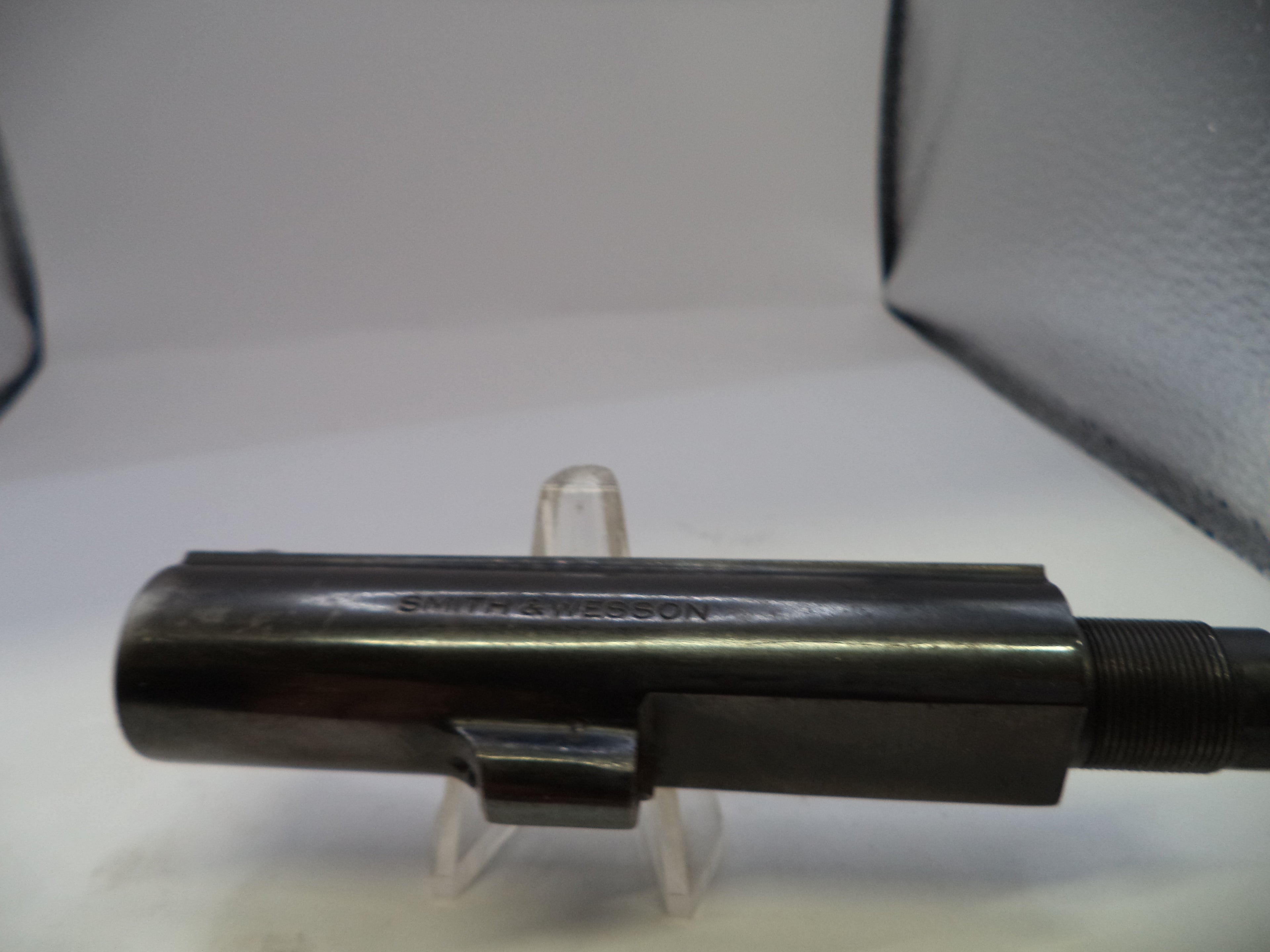 Metallic object on a stand with a white background