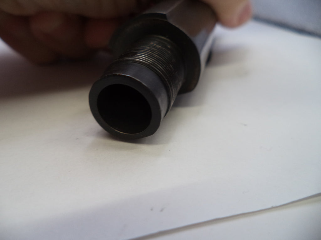 Close-up of a cylindrical metal object on a white surface