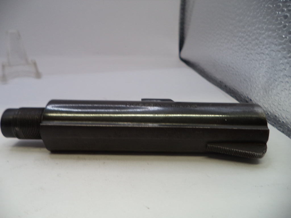 Metal cylindrical object on a white surface with a gray background