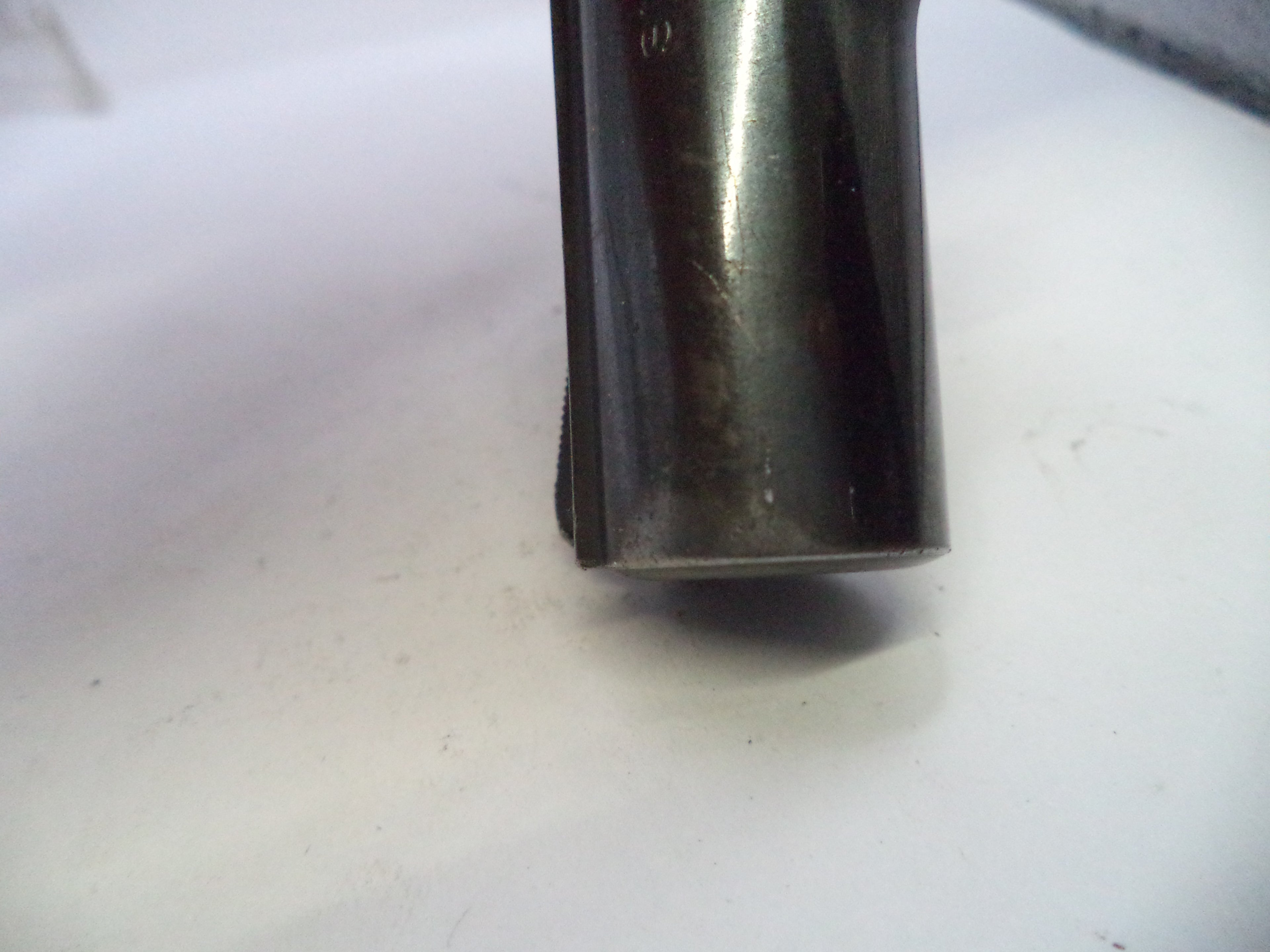 Metallic object on a white surface