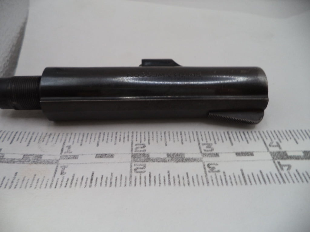 Black cylindrical object on a white surface with measurement markings