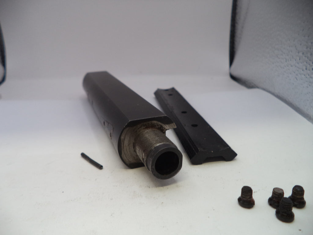 Metal components and screws on a white surface