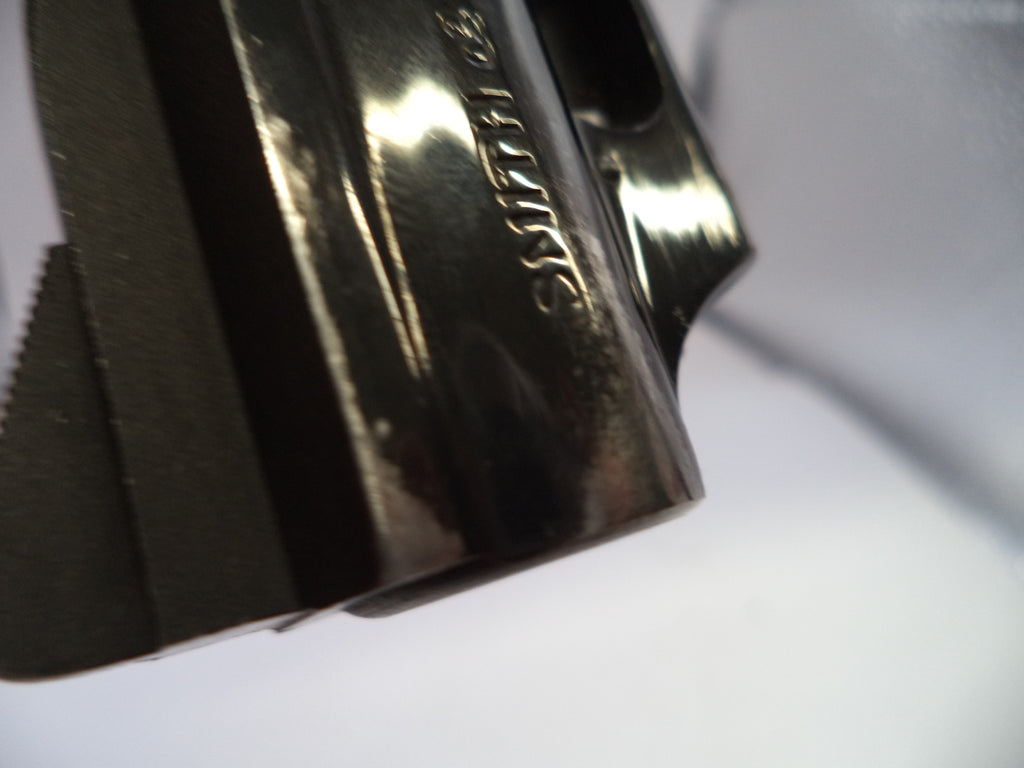 Metallic object with engraved text on a white background