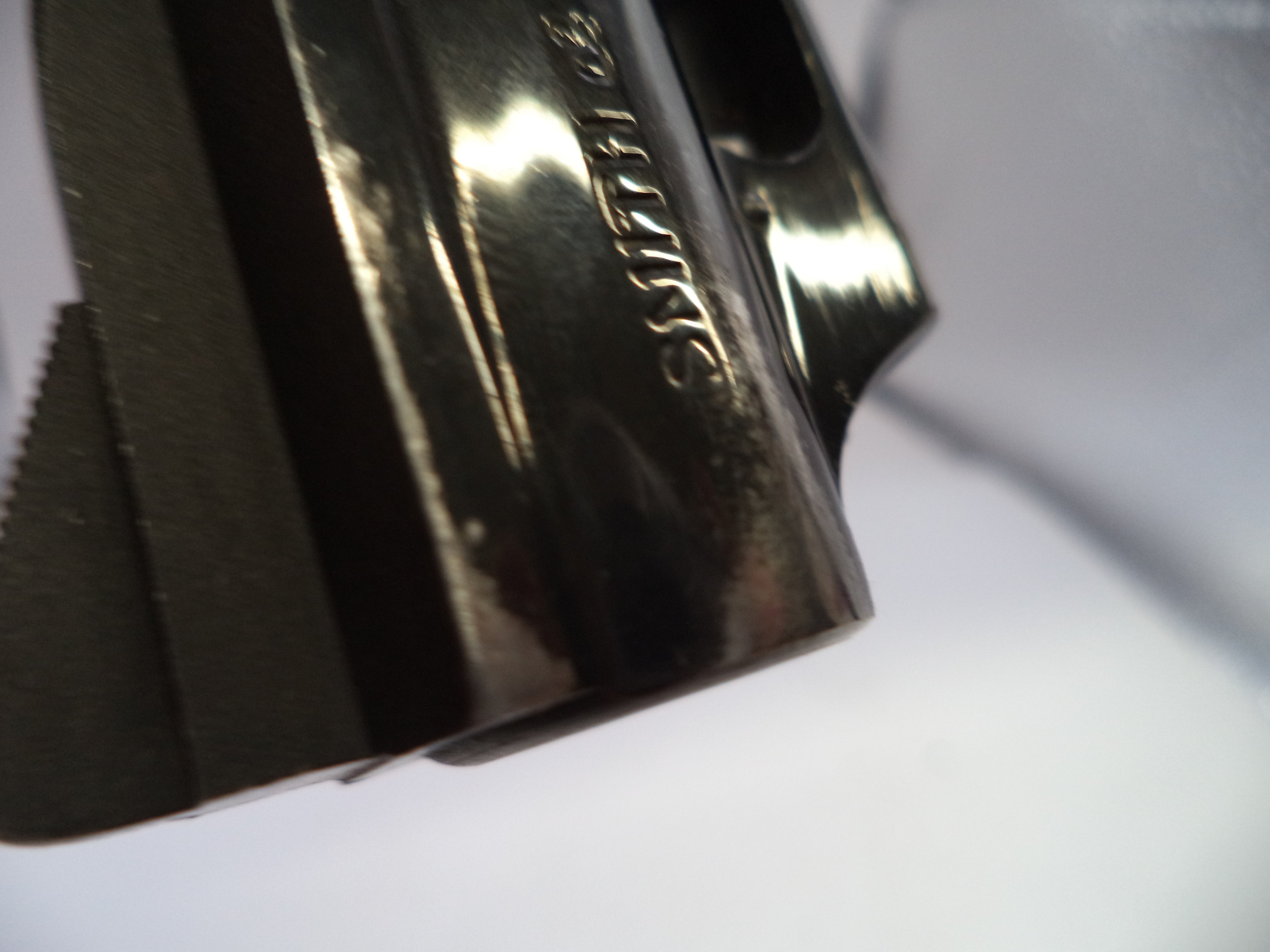 Metallic object with engraved text on a white background