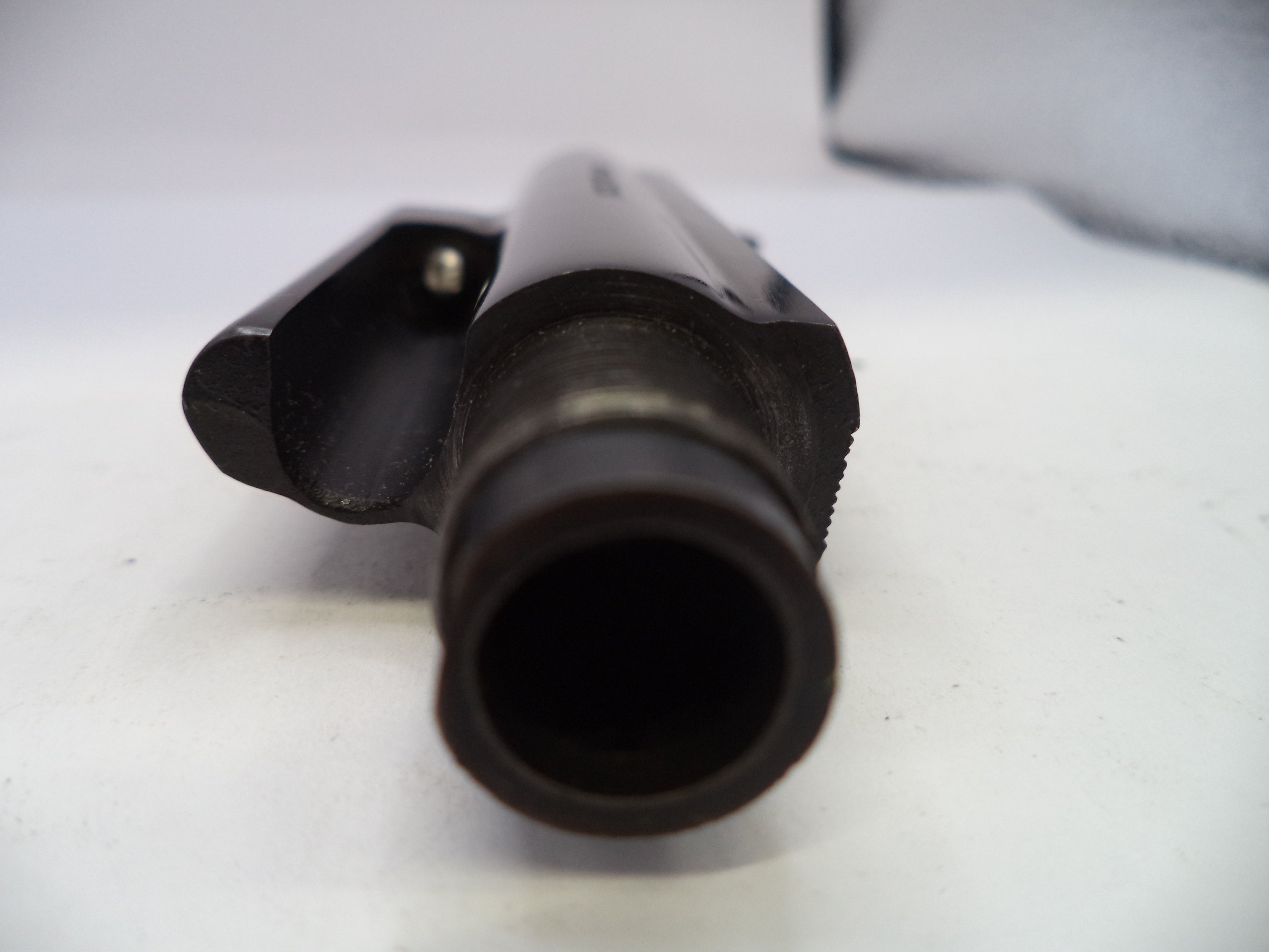 Close-up of a black cylindrical object on a white background