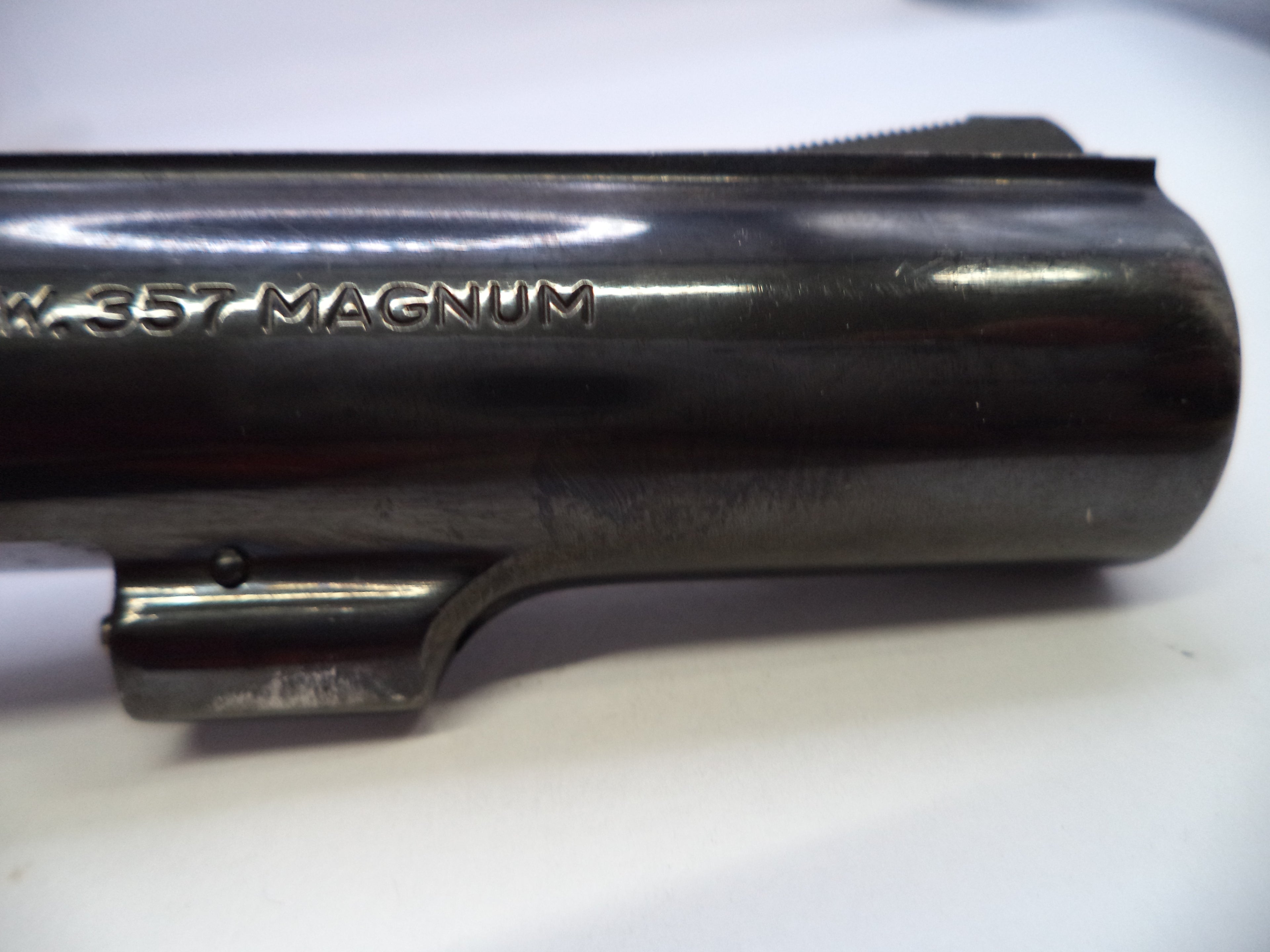 Close-up of a gun barrel with '357 Magnum' engraving on a white background