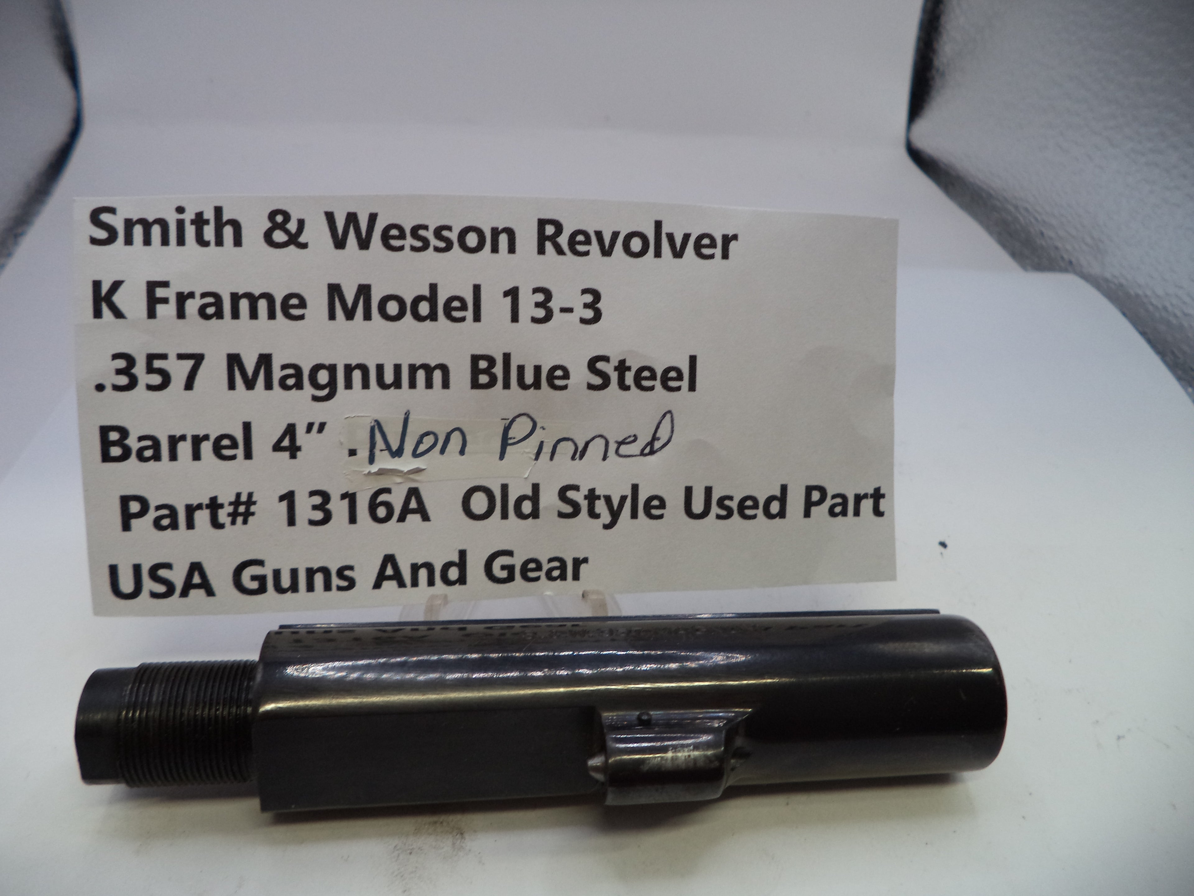 Smith & Wesson revolver part with descriptive label on a white background