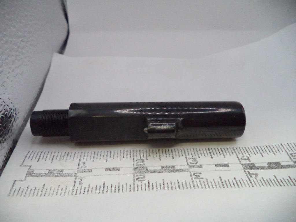 Black cylindrical object on a white surface with printed text