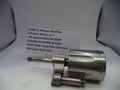 Smith & Wesson revolver cylinder assembly on a white surface with a label in the background.