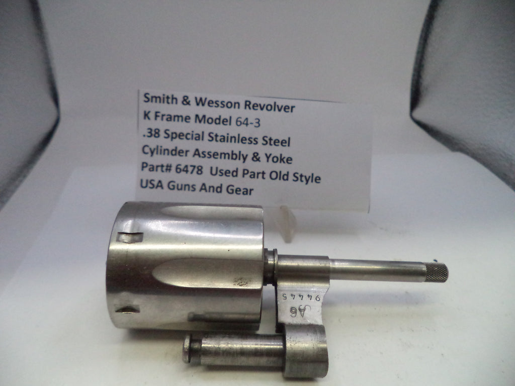 Smith & Wesson revolver cylinder assembly on a white background with a label.