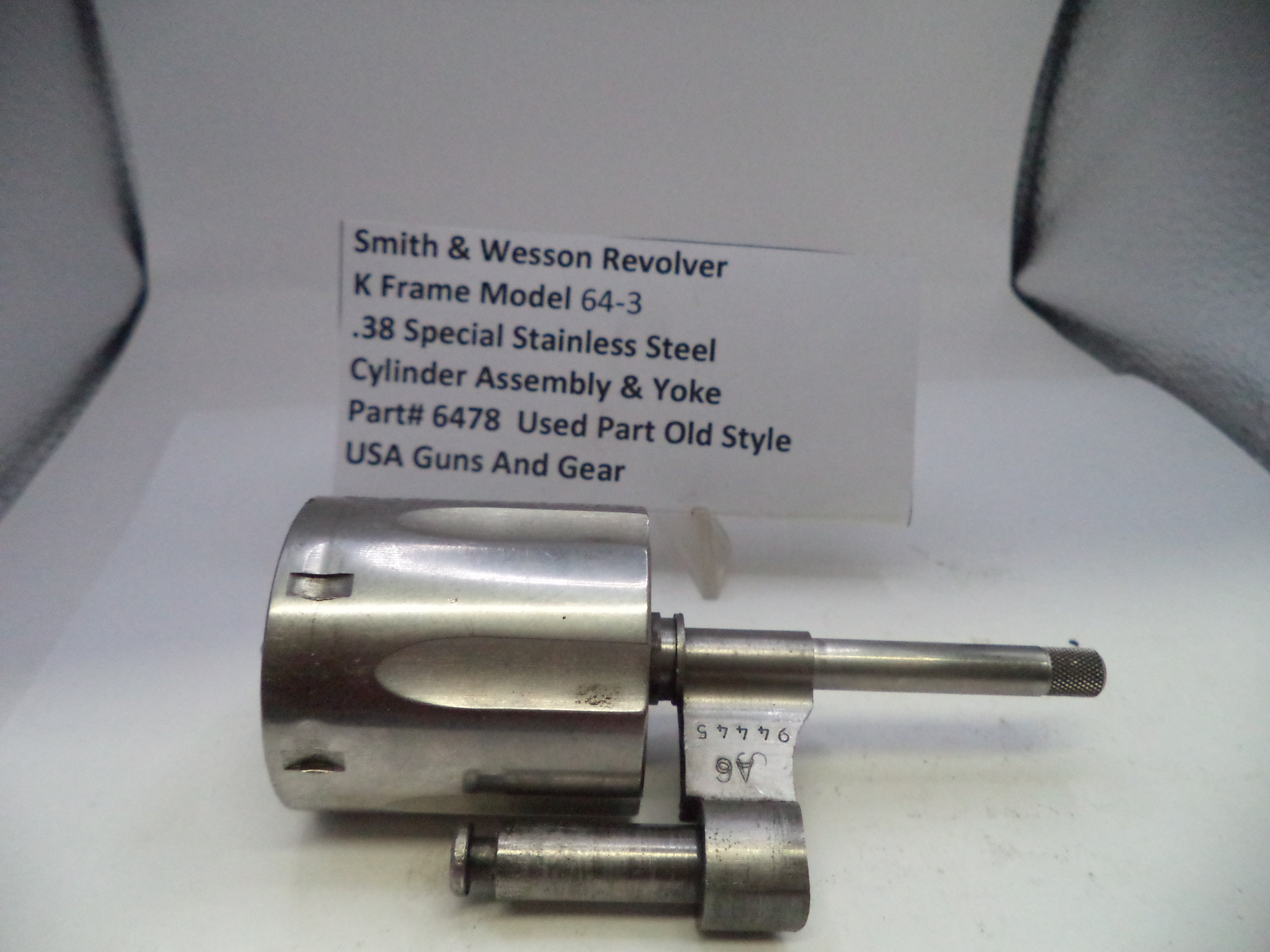 Smith & Wesson revolver cylinder assembly on a white background with a label.