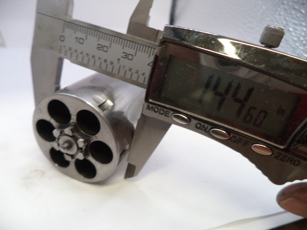 Digital caliper measuring a cylindrical metal object with a white background