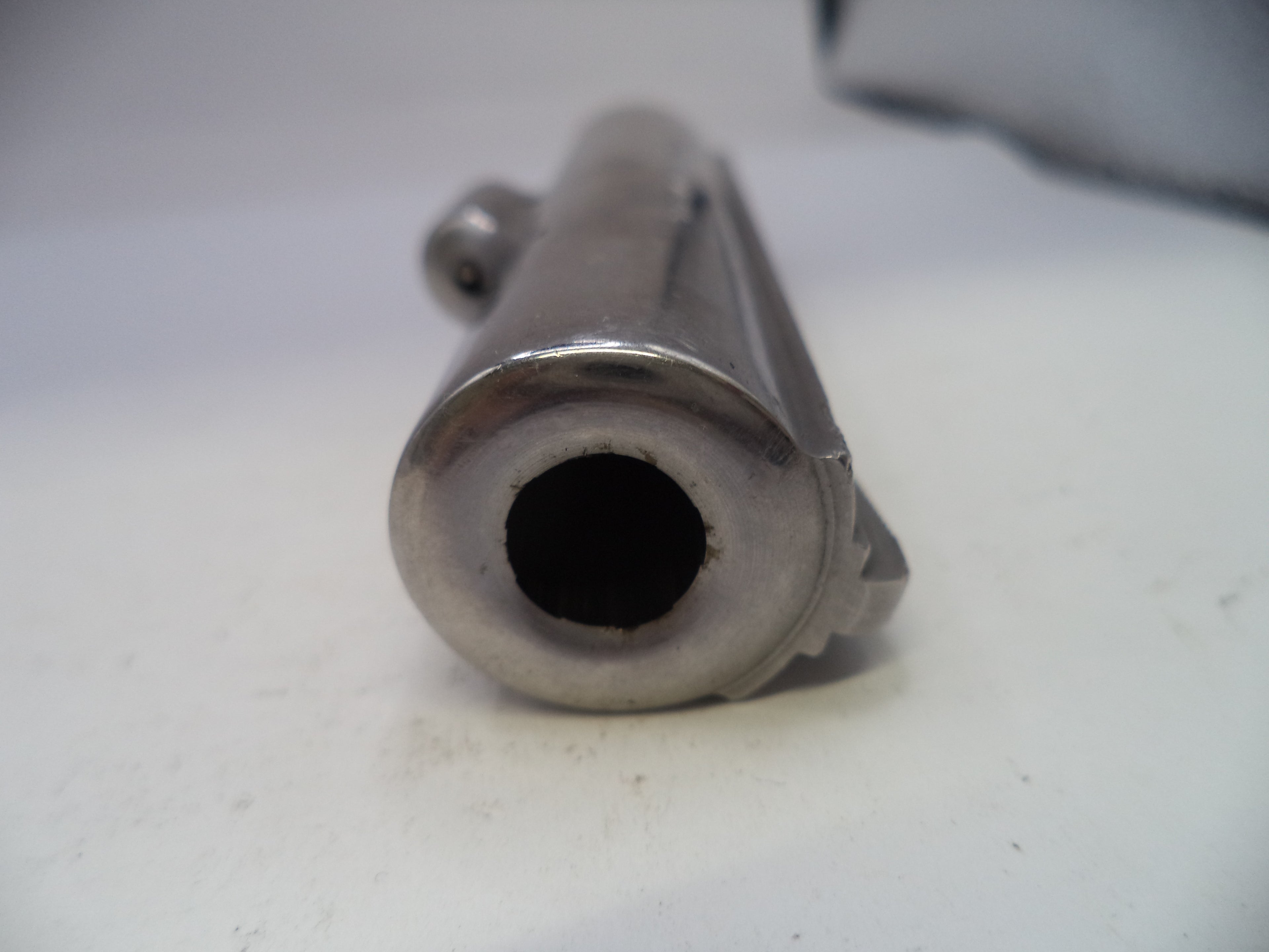 Close-up of a metallic exhaust pipe on a white background