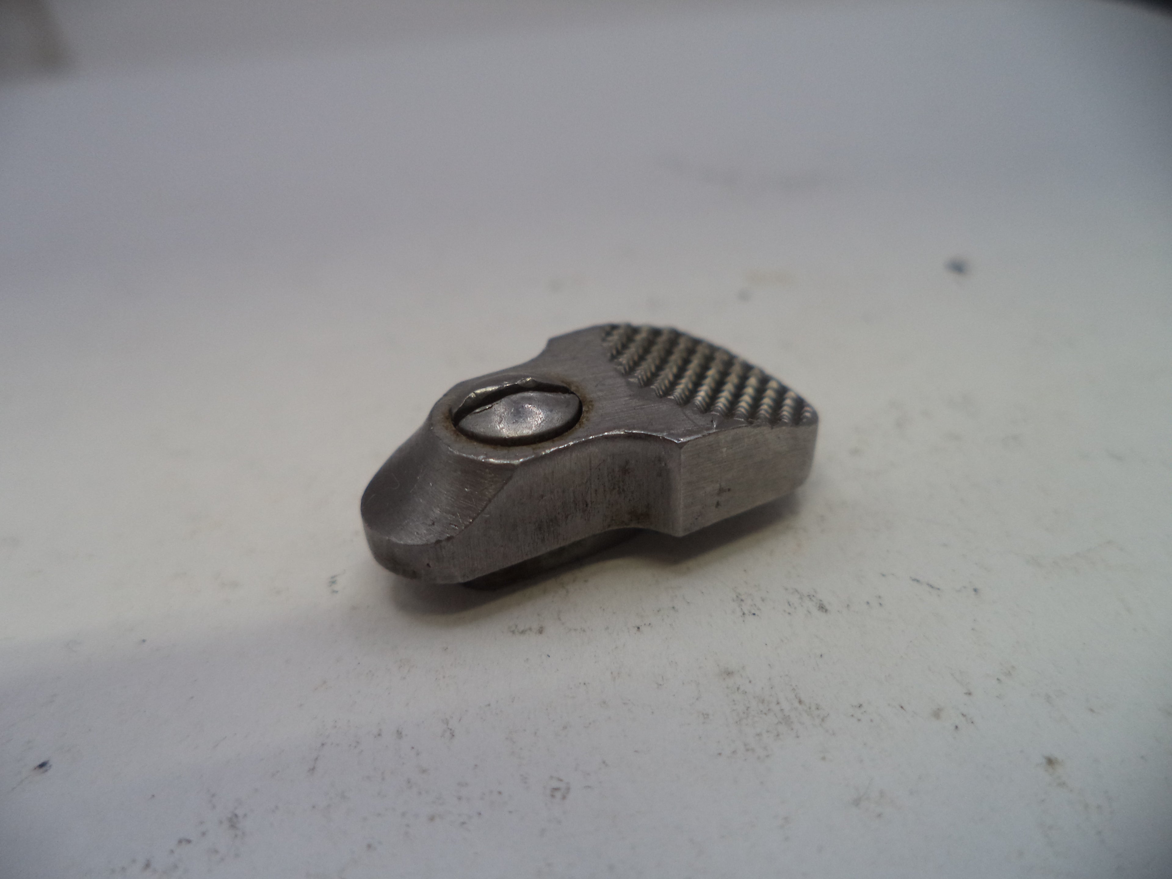 Metallic object with textured surface on a white background